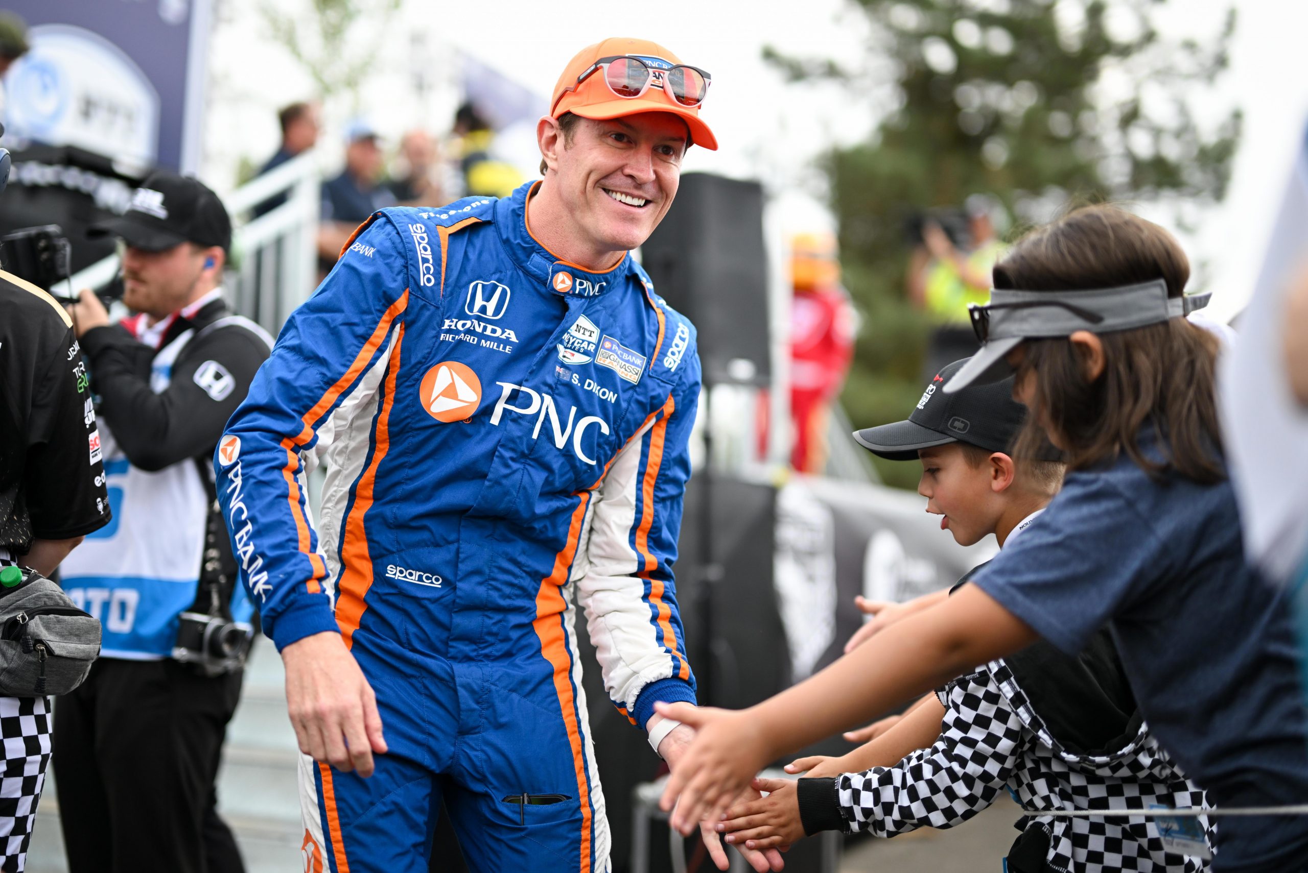 Six-time IndyCar champion Scott Dixon greets fans.