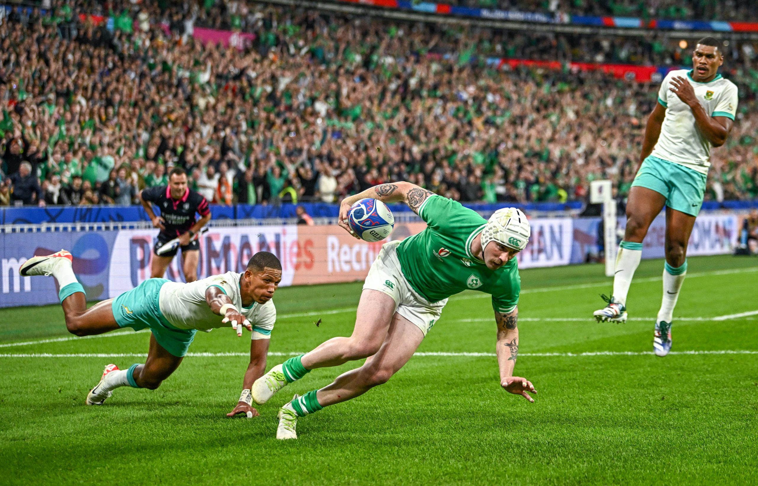 Mack Hansen of Ireland dives over to score his side's first try despite the efforts of Manie Libbok of South Africa.