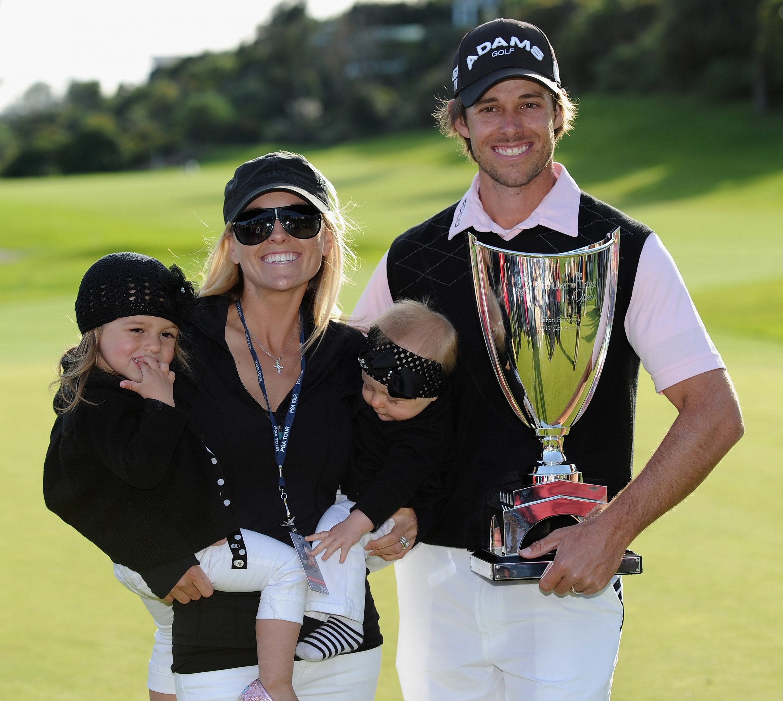 Aaron Baddeley of Australia poses his wife Richelle, daughters Jewel and Jolee and the tournament trophy after winning the final round of the Northern Trust Open at Riviera Country Club on February 20, 2011 in Pacific Palisades, California. (Photo by Stuart Franklin/Getty Images)