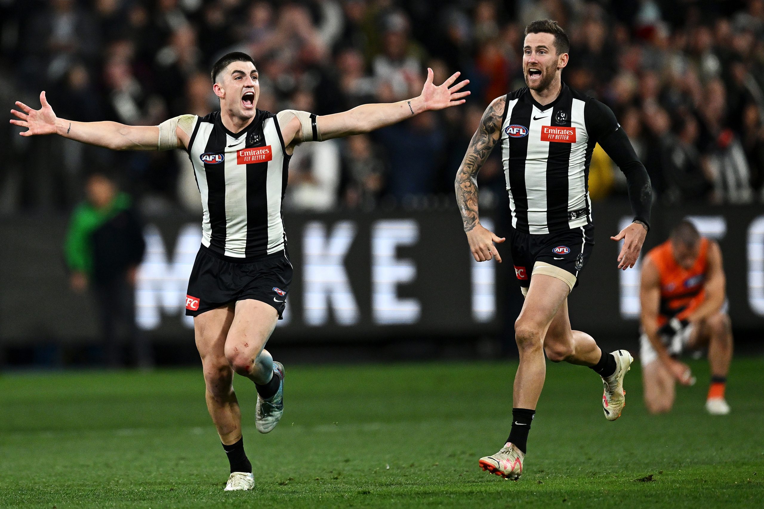 Brayden Maynard overjoyed on the final siren, followed closely by teammate Jeremy Howe.