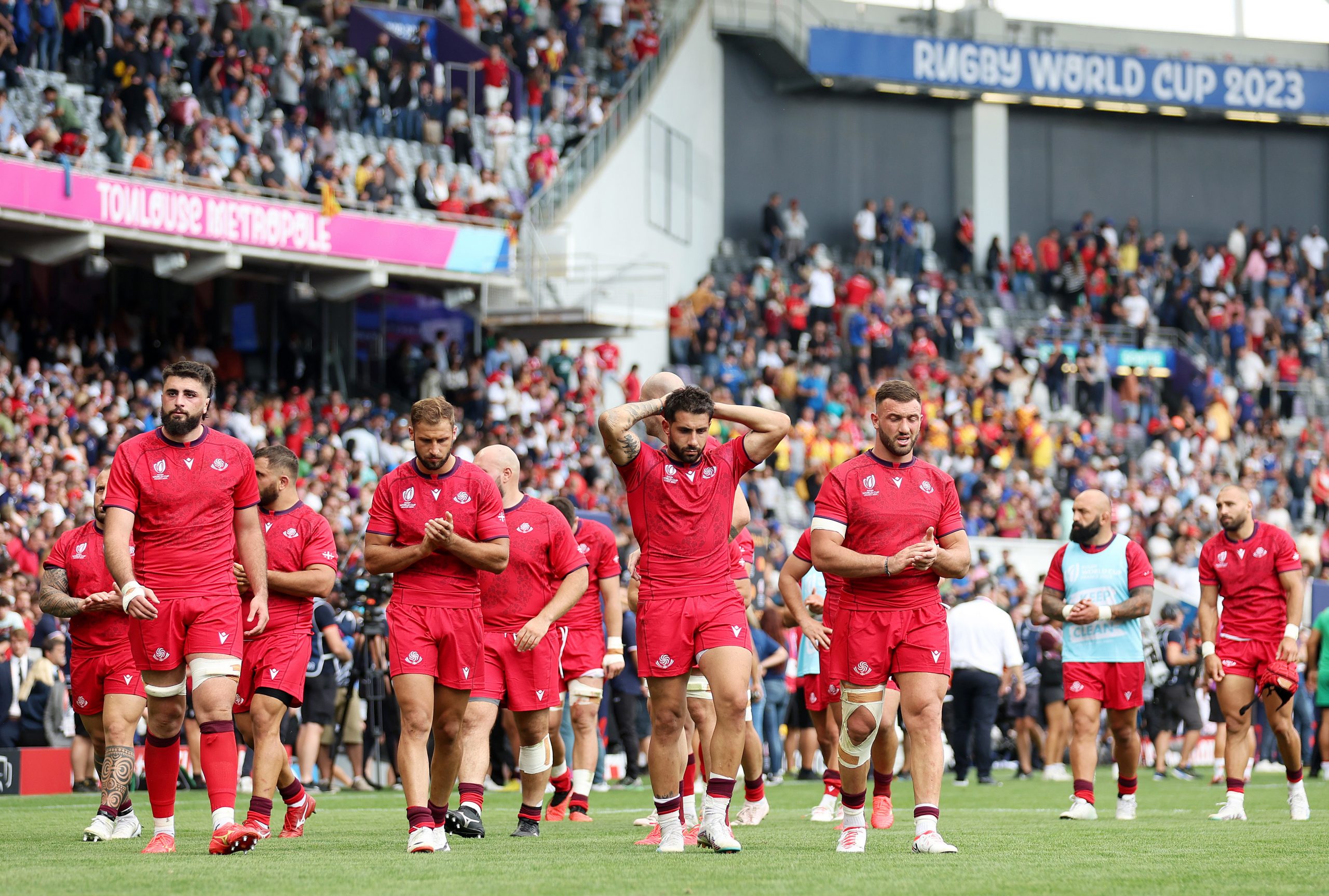 Stunned Georgia players wander after their drawn match against Portugal.