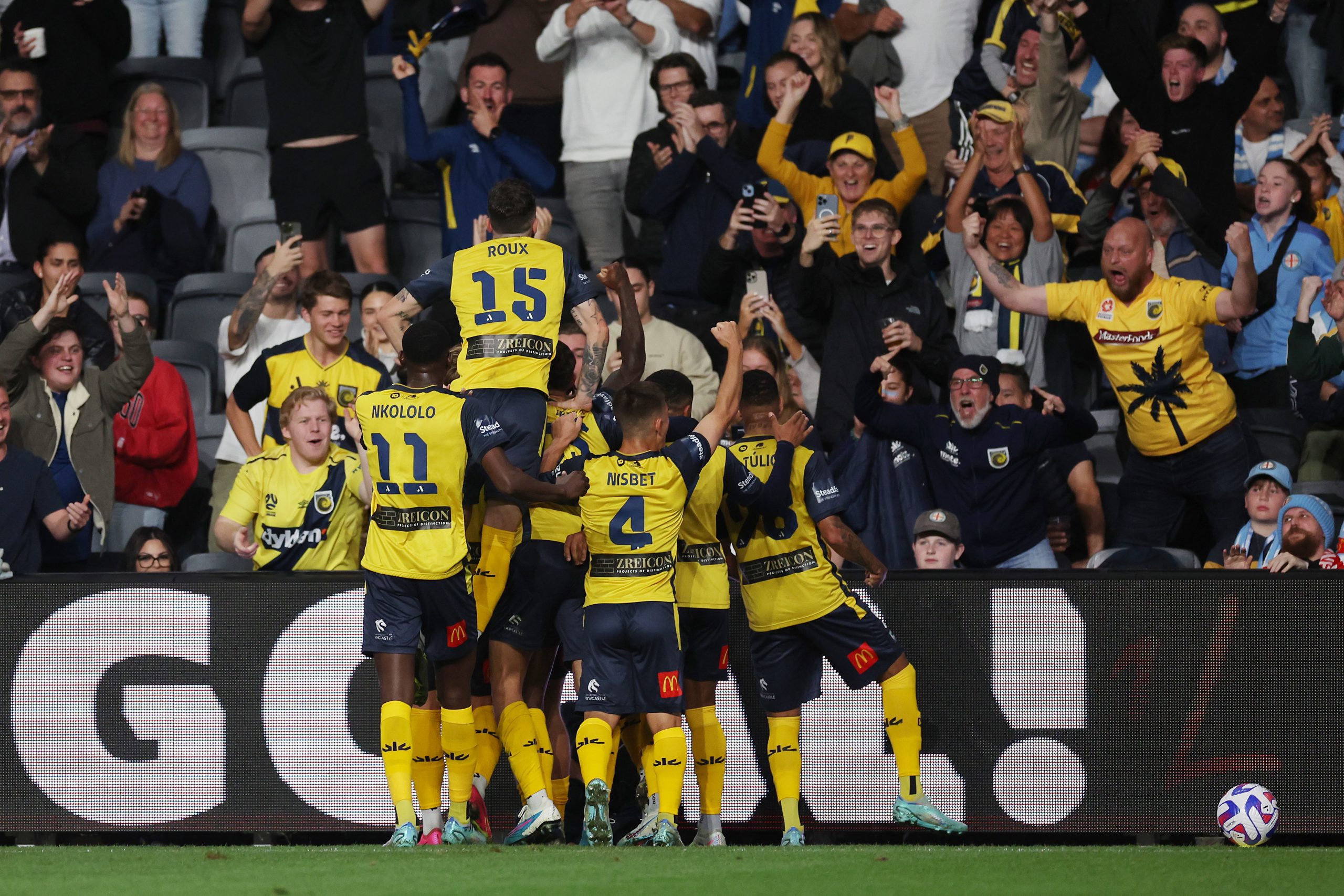 Jason Cummings of the Mariners celebrates with team mates after kicking a goal during the 2023 A-League Men's Grand Final match between Melbourne City and Central Coast Mariners.