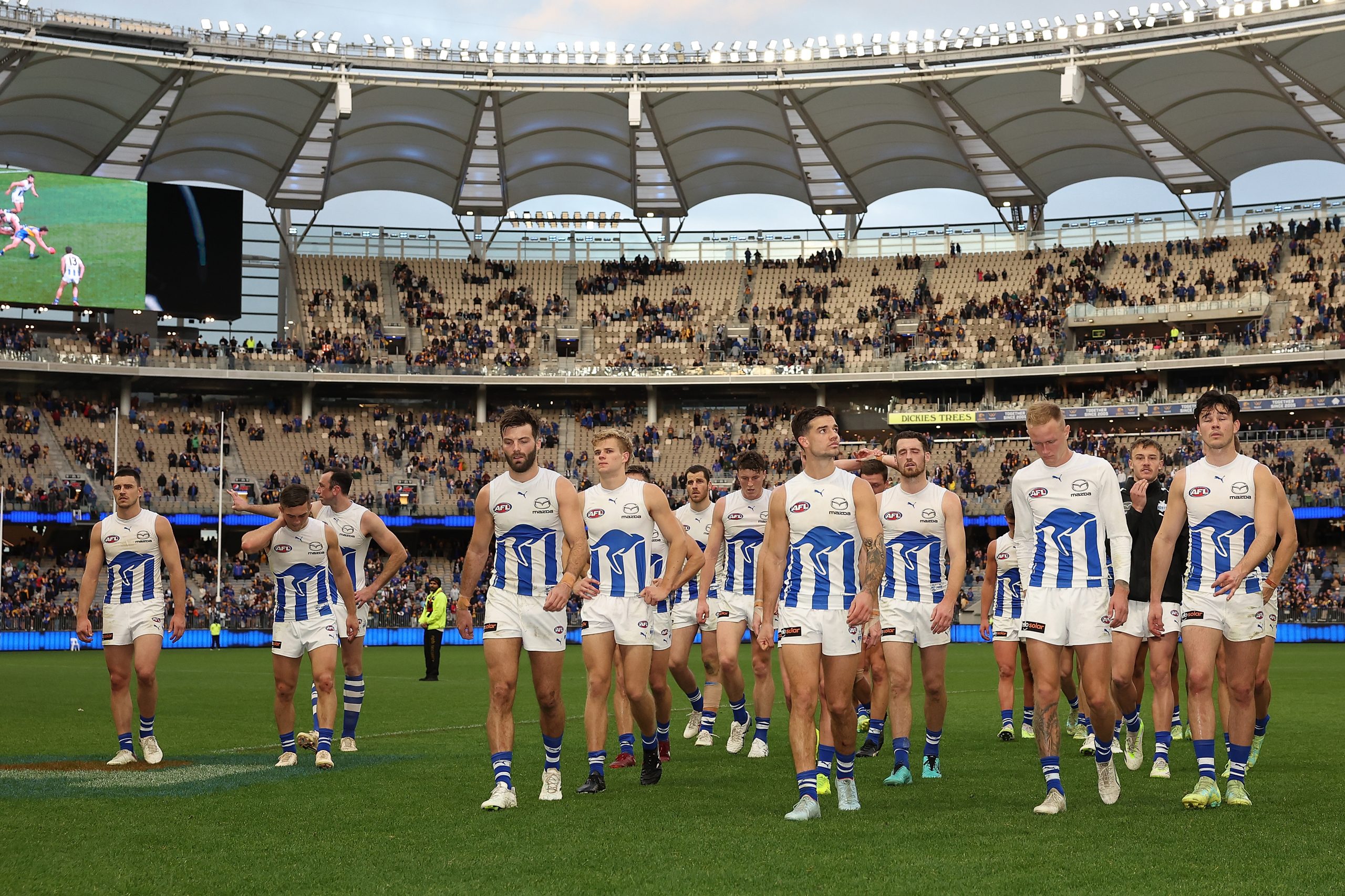 PERTH, AUSTRALIA - JULY 30: The Kangaroos walk from the field after being defeated during the round 20 AFL match between West Coast Eagles and North Melbourne Kangaroos at Optus Stadium, on July 30, 2023, in Perth, Australia. (Photo by Paul Kane/Getty Images)