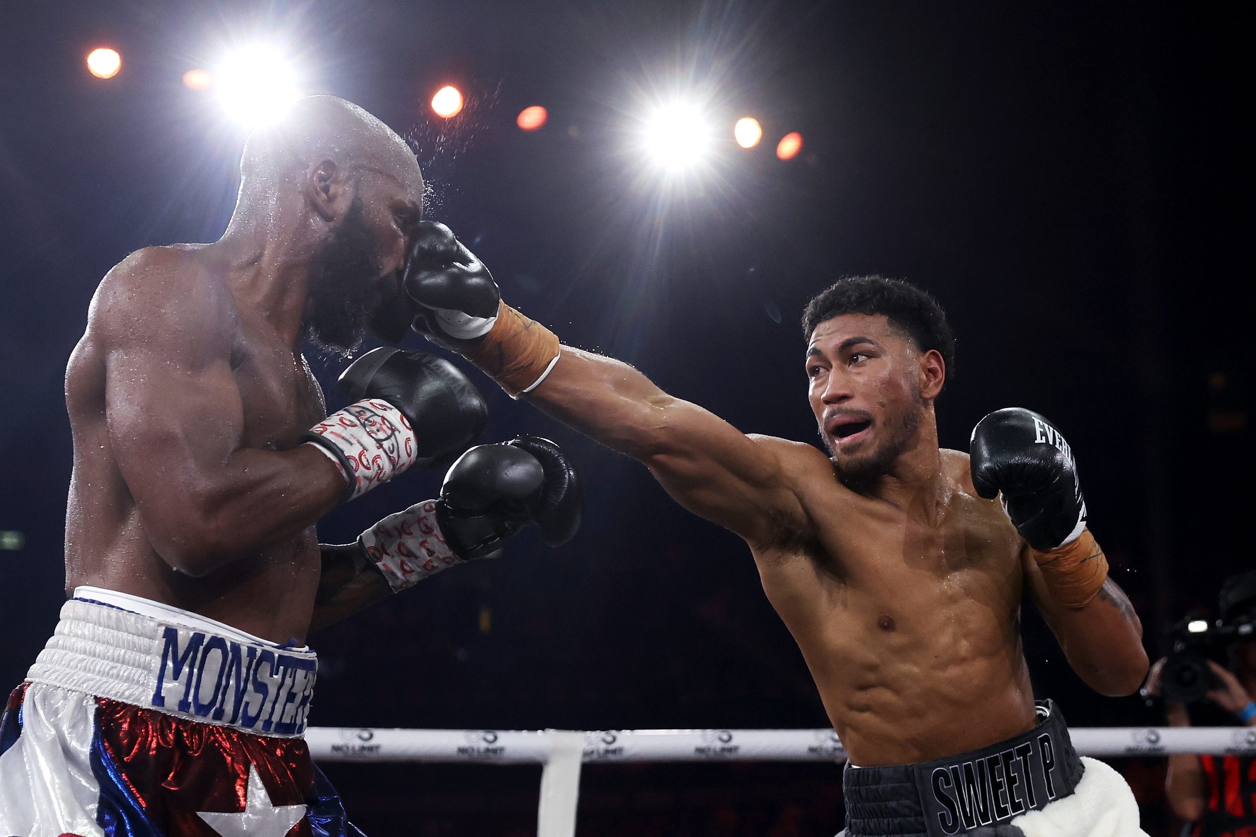 Yunieski Gonzalez (left) is punched by Paulo Aokuso during the light heavyweight bout between at Qudos Bank Aren.