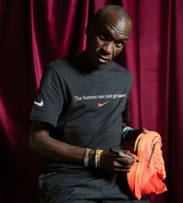 Eliud Kipchoge signs a pair of Nike Air Zoom Alphafly Next%.