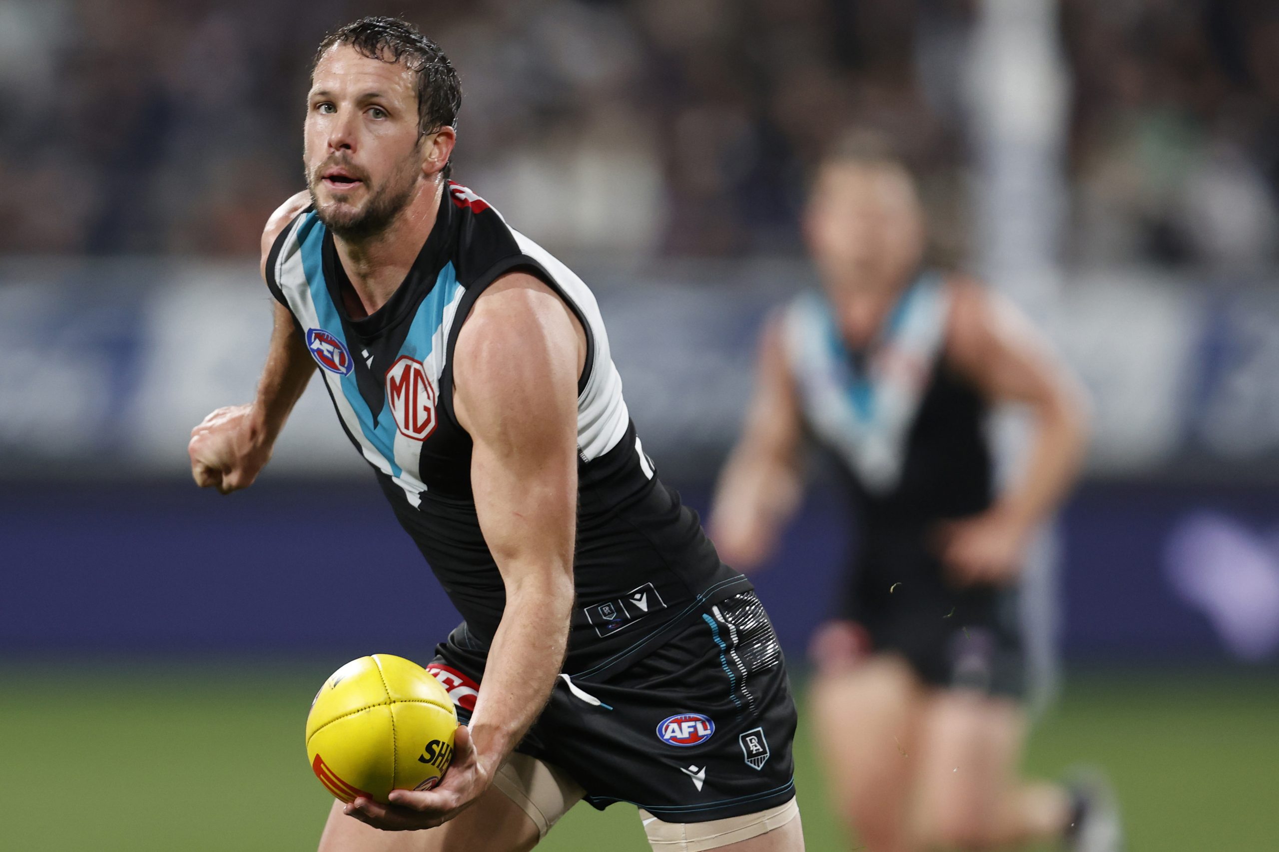 Port Adelaide's Travis Boak makes a handball.