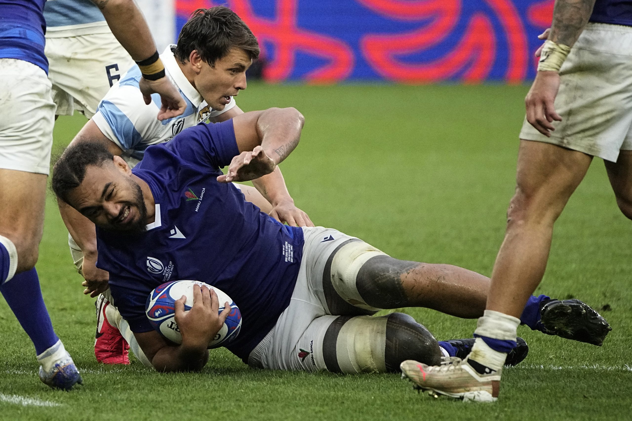 Samoa's captain Chris Vui is tackled by Argentina's Matias Alemanno.