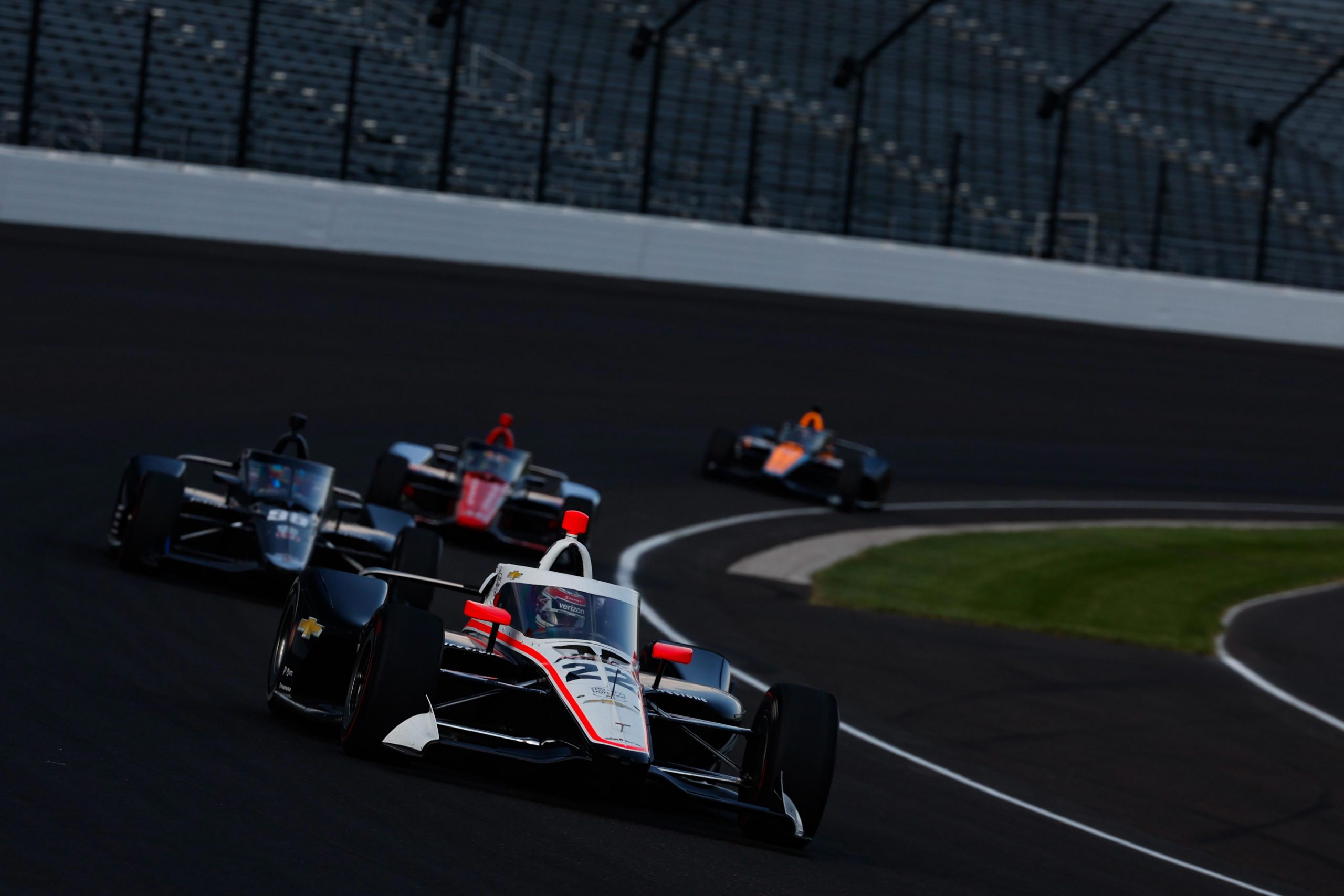 Will Power leads a pack of cars at Indianapolis Motor Speedway.