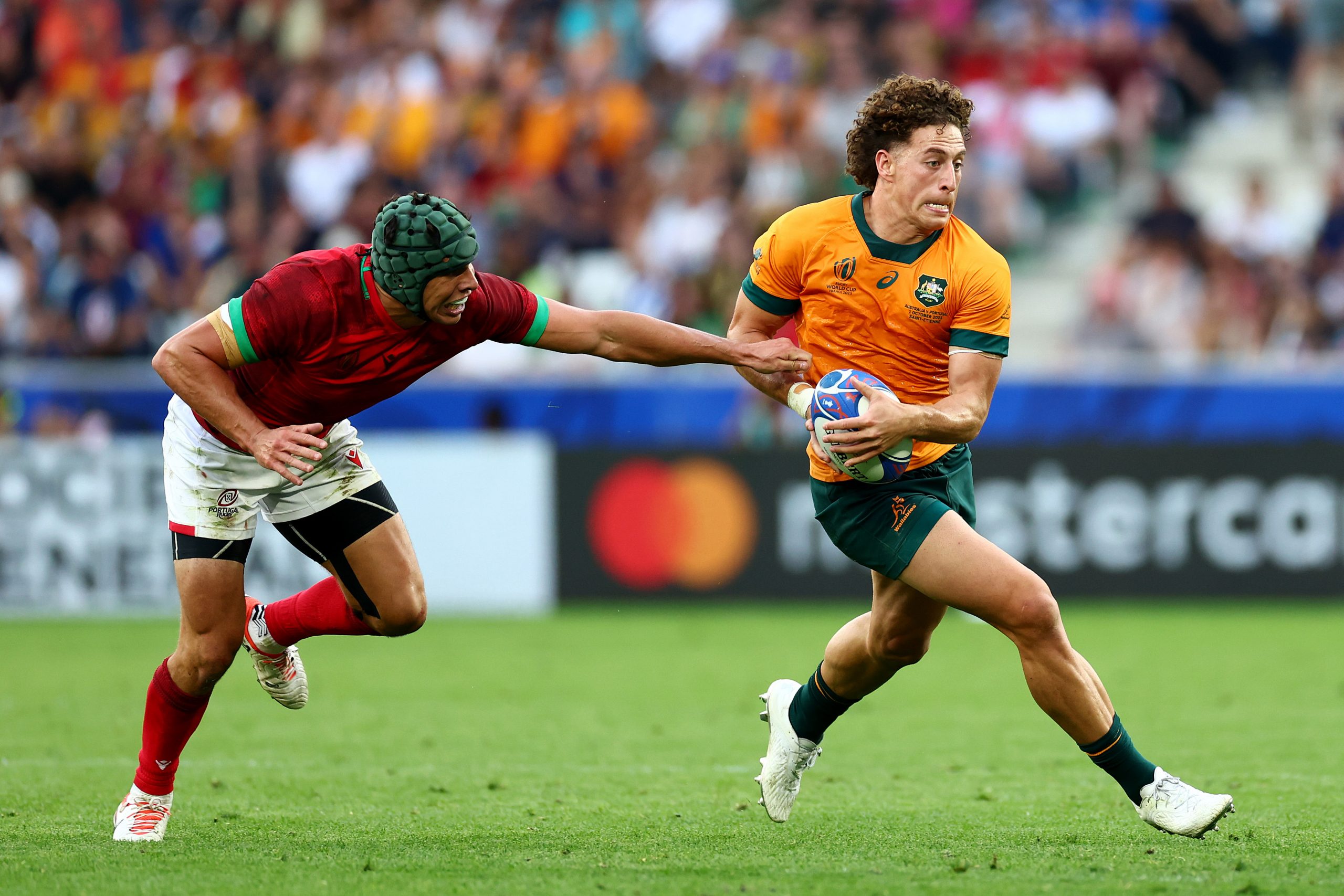Mark Nawaqanitawase of Australia is tackled by Portugal's Pedro Bettencourt.