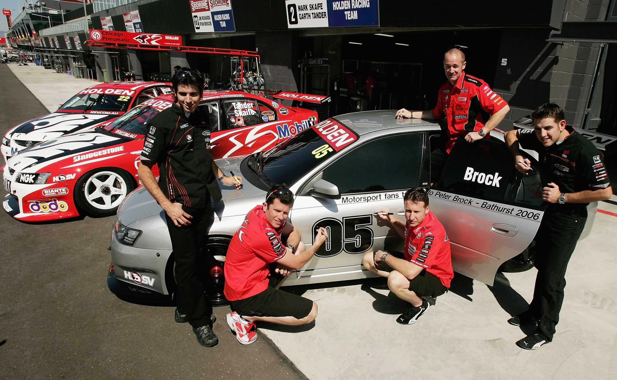 Holden drivers Rick Kelly, Garth Tander, Mark Skaife, Greg Murphy and Todd Kelly sign  the Brock Tribute Car prior to the Bathurst 1000 V8 Supercars race at the Mount Panorama circuit October 4, 2006 in Bathurst, Australia. Holden Special Vehicles is giving fans the chance to sign the car, which will then be offered to a museum as a memorial. Brock, 61, was killed in a single car accident while competing in the Targa West rally in West Australia. He was dubbed "