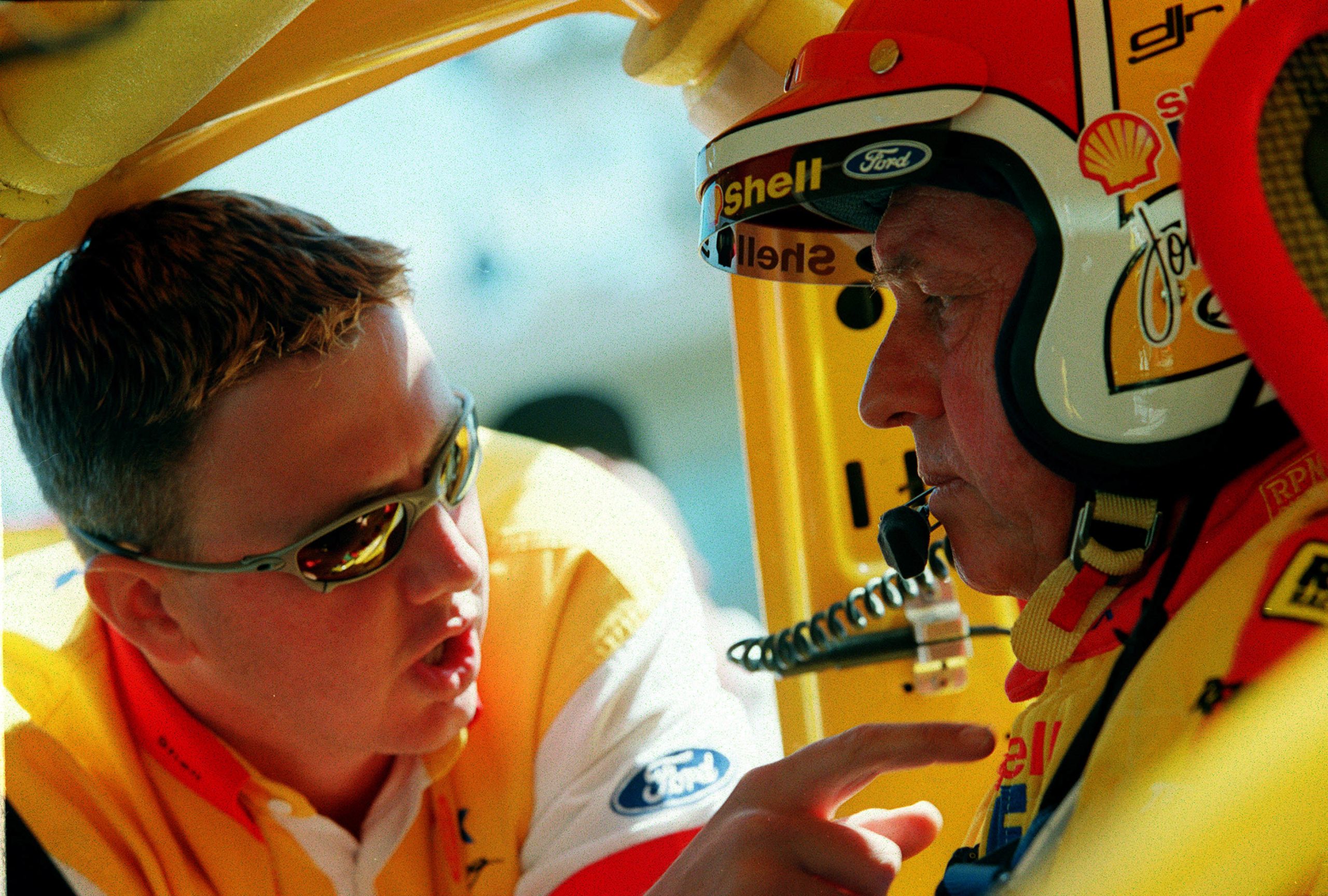 Steven Johnson and Dick Johnson from the Shell Helix racing team talk tactics in the Ford during the practice rounds of the Bathurst FAI 1000 at Mount Panorama,Bathurst Australia. Mandatory Credit: Adam Pretty/ALLSPORT