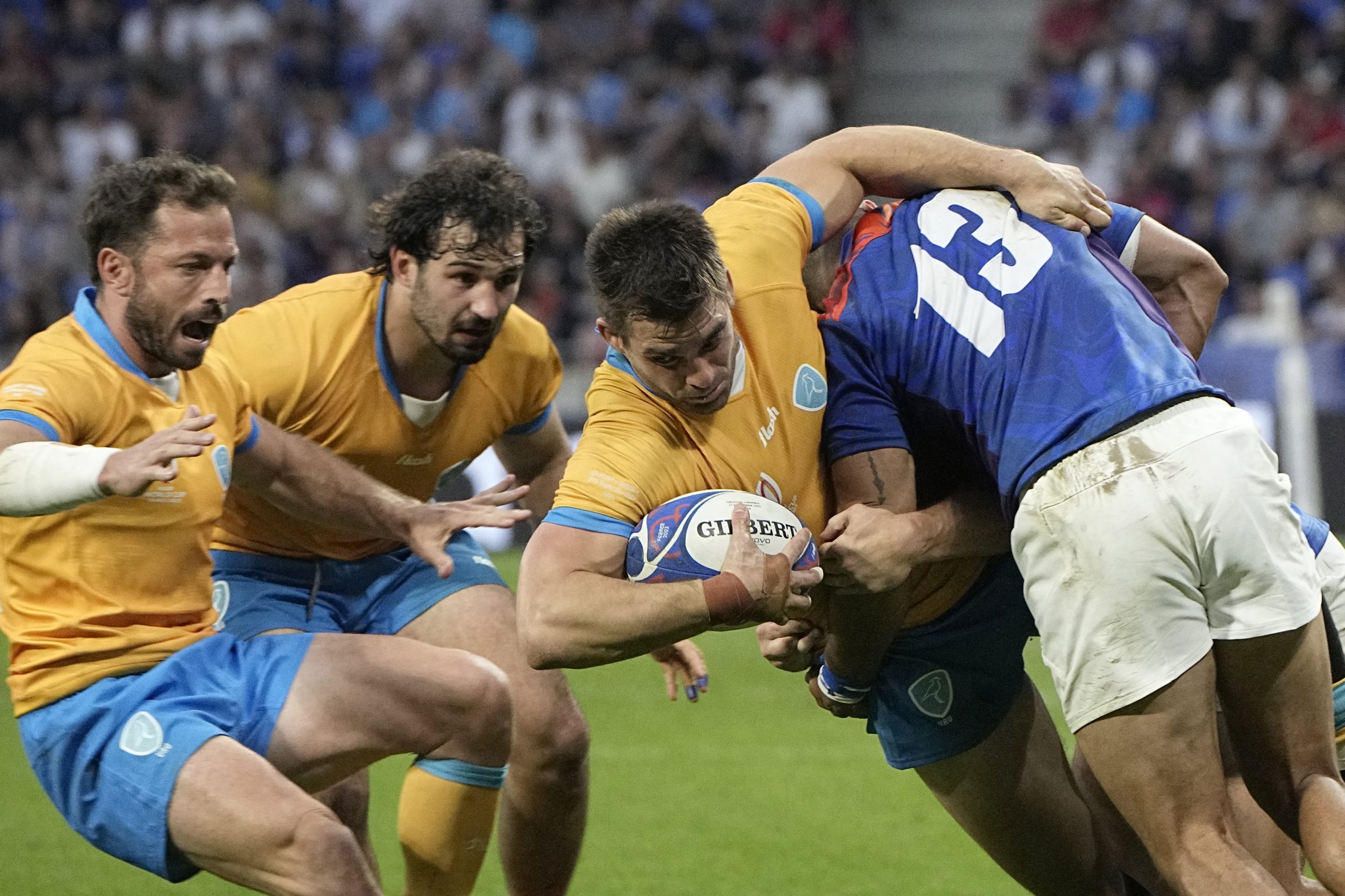 Uruguay's Andres Vilaseca is tackled by Namibia's Alcino Izaacs.