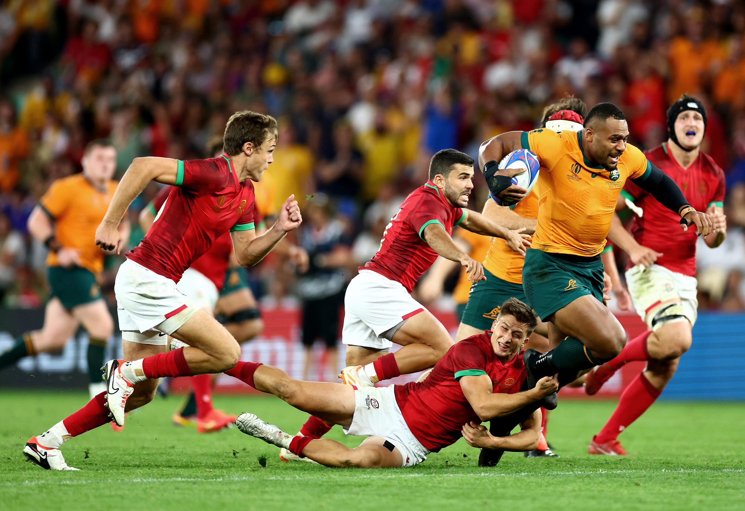 Samu Kerevi of Australia is tackled by Rodrigo Marta of Portugal.