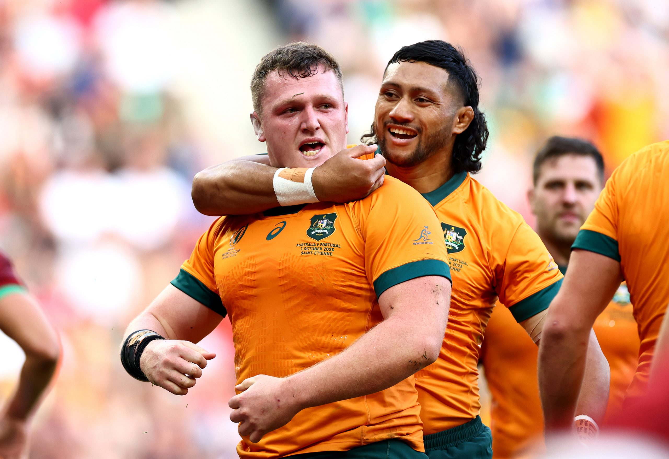 Angus Bell of Australia celebrates with Rob Leota after scoring his team's third try.