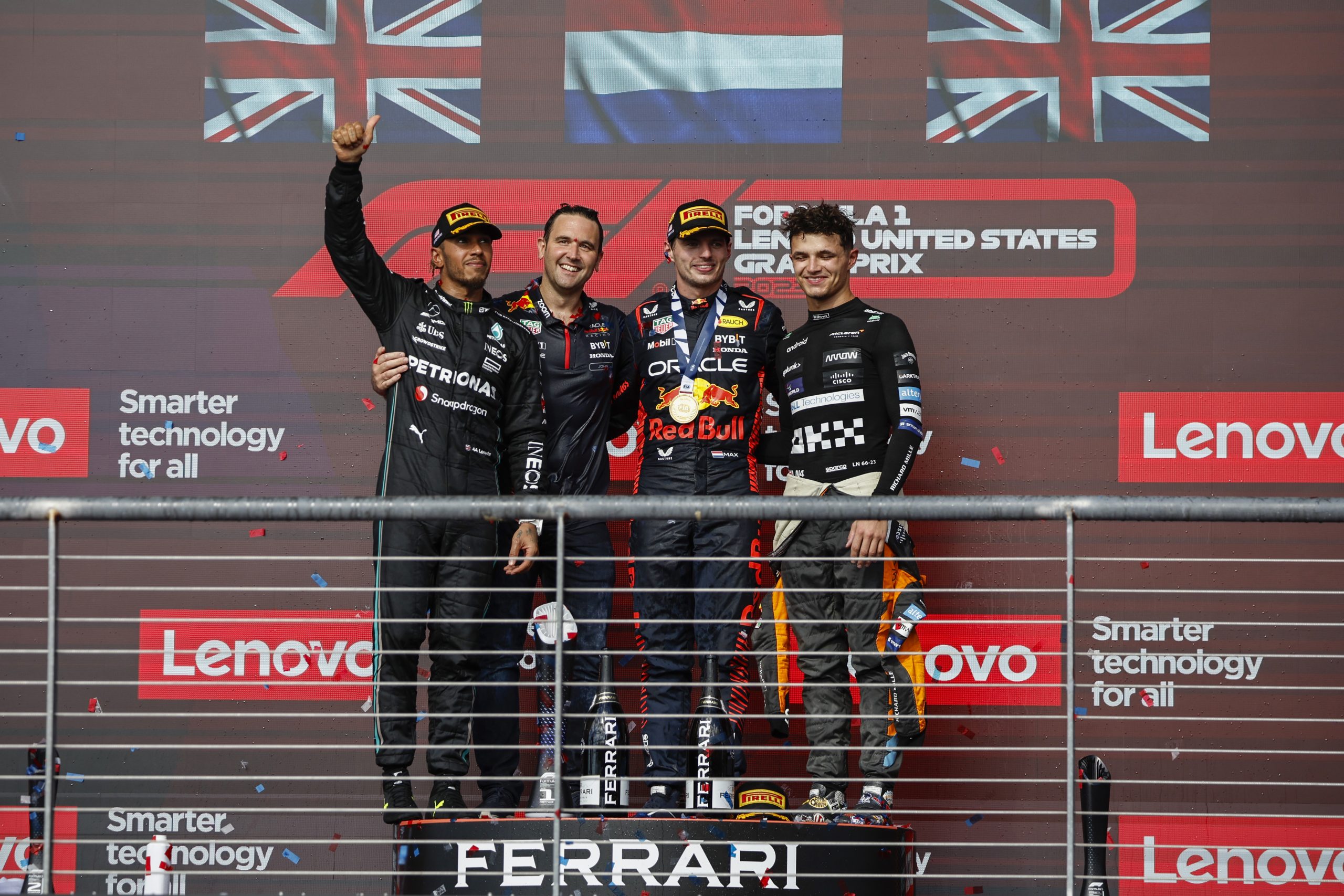 Race winner Max Verstappen alongside Lewis Hamilton, Lando Norris and Red Bull's John Hammond celebrate on the podium following the United States Grand Prix.