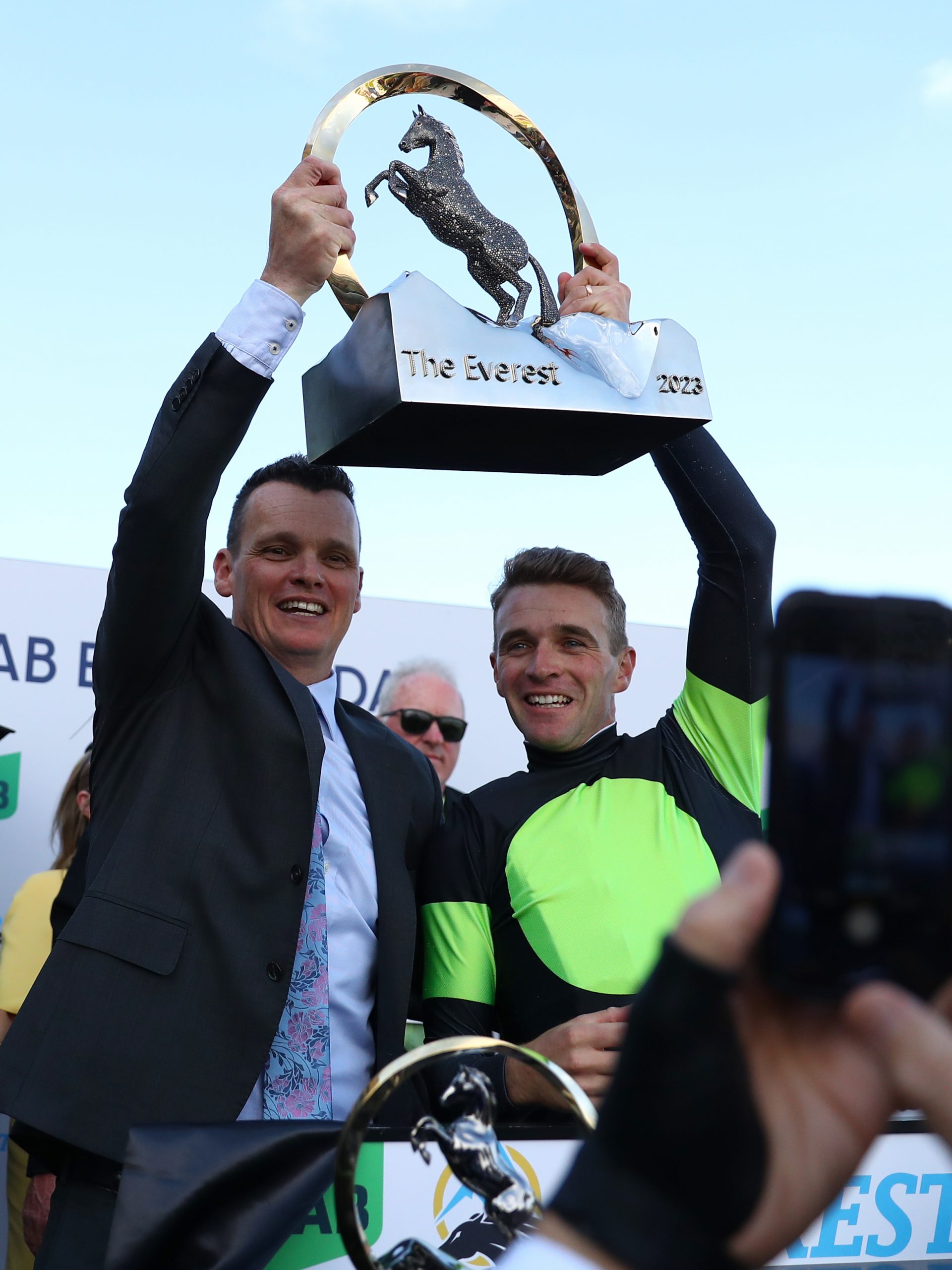 Trainer Joseph Pride (left) and jockey Sam Clipperton hoist The Everest trophy.