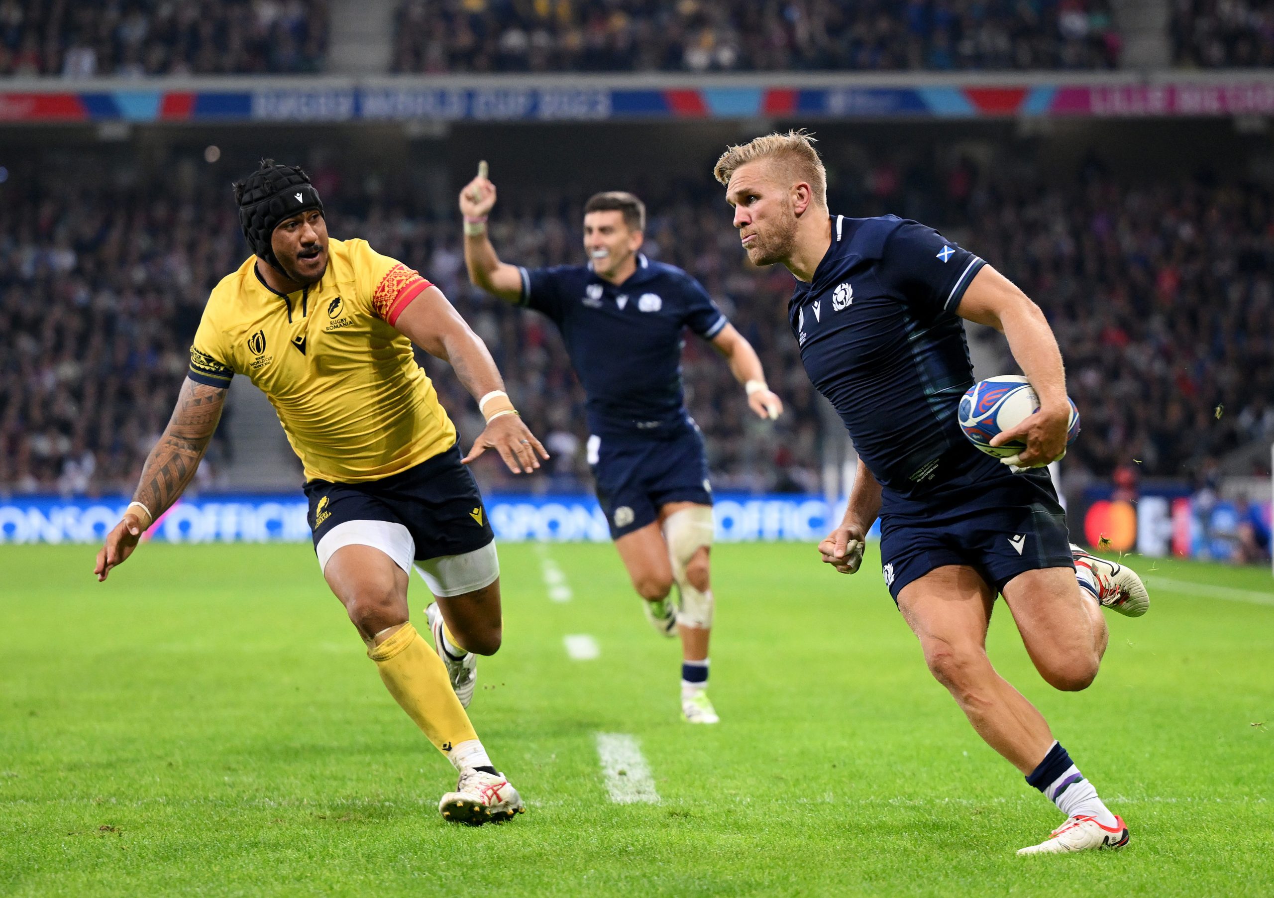 Chris Harris of Scotland scores the team's seventh try against Romania.