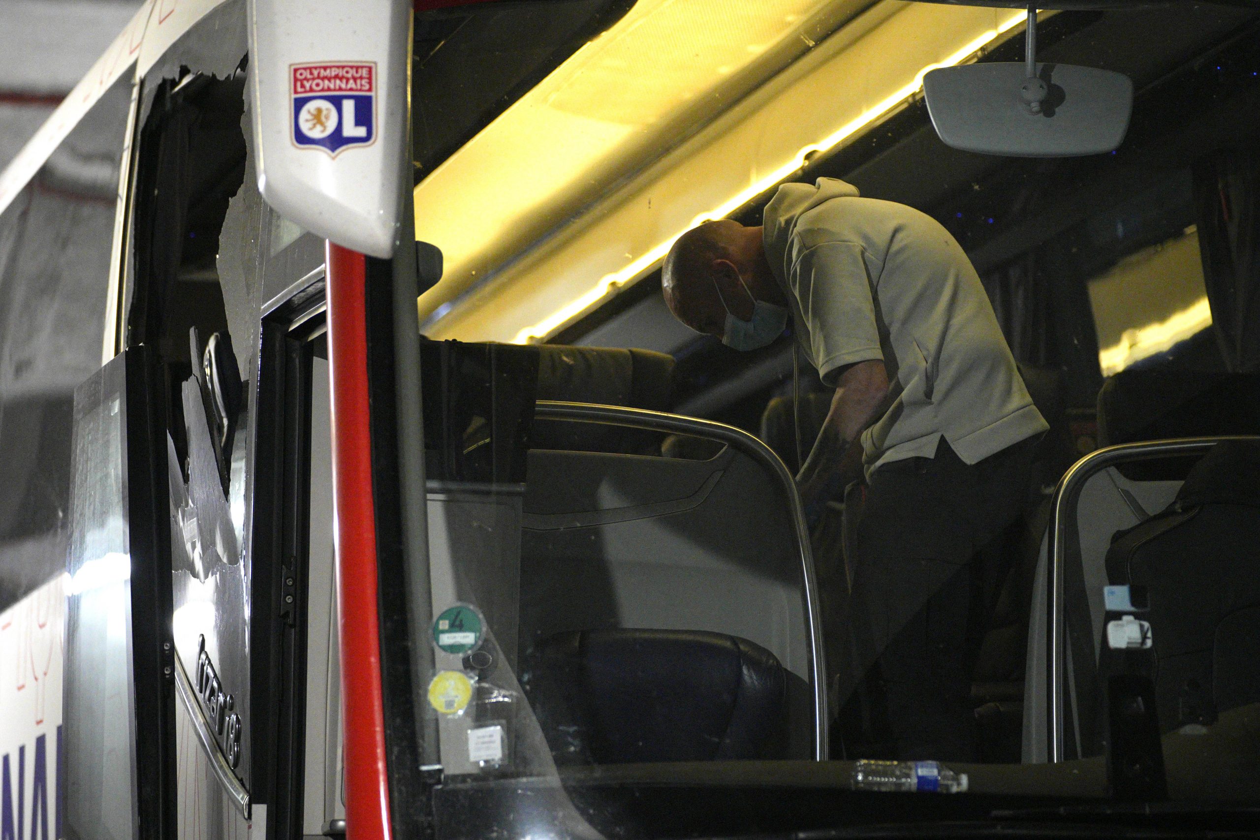 Police take finger prints in a bus that the Lyon soccer team were traveling in.