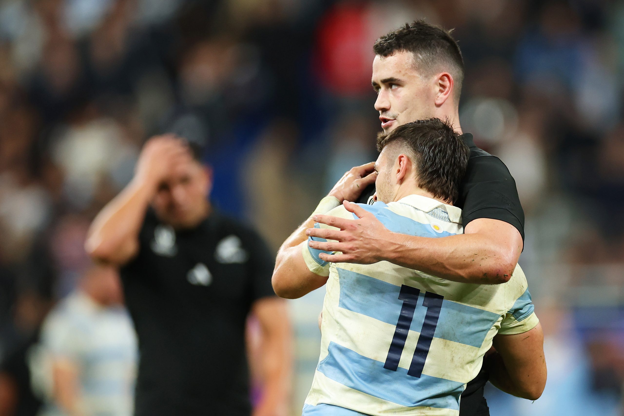 Will Jordan of New Zealand embraces Mateo Carreras of Argentina.