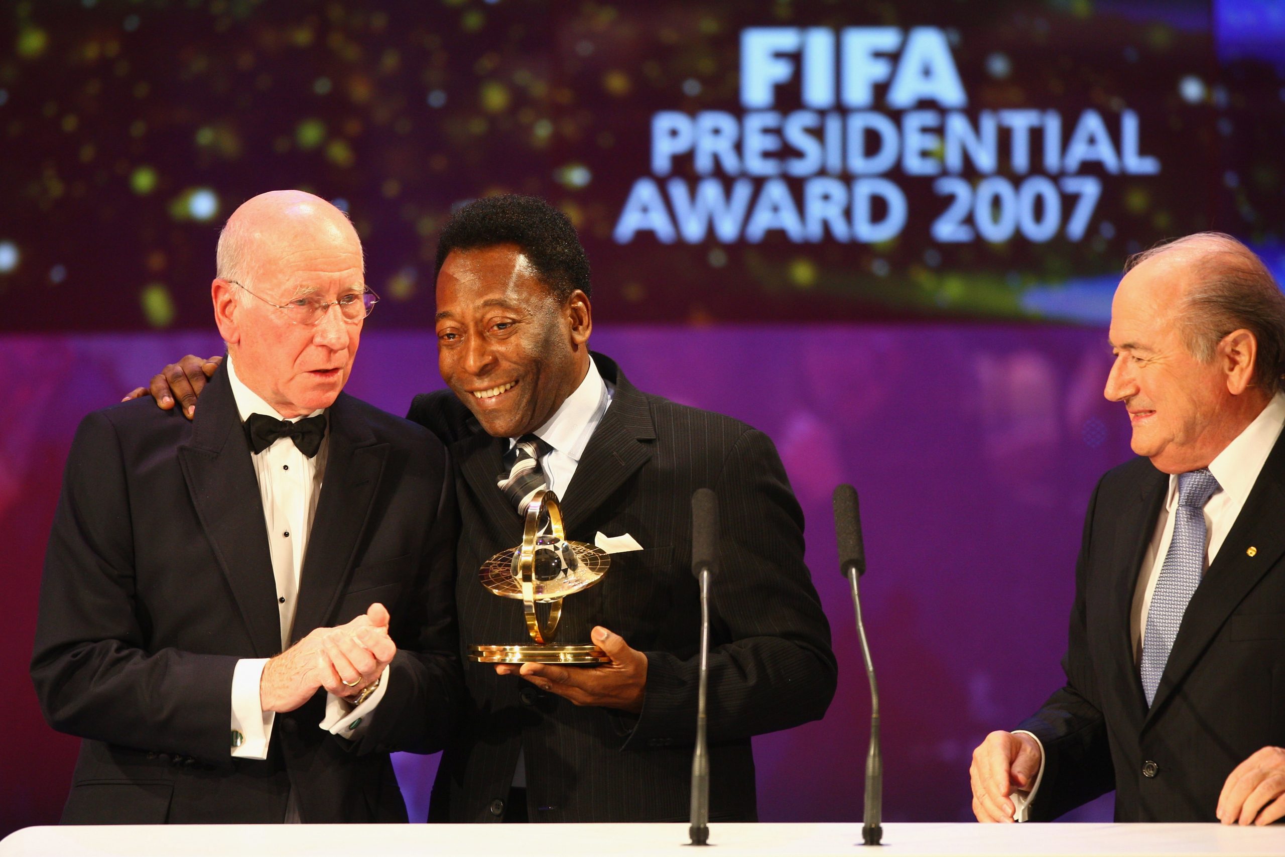Pele (C) receives the Presidents Award from Sir Bobby Charlton (L) as Fifa President Sepp Blatter looks on during the FIFA World Player of The Year Gala 2007 at the Zurich Opera House on December 17, 2007 in Zurich, Switzerland. (Photo by Michael Steele/Getty Images)