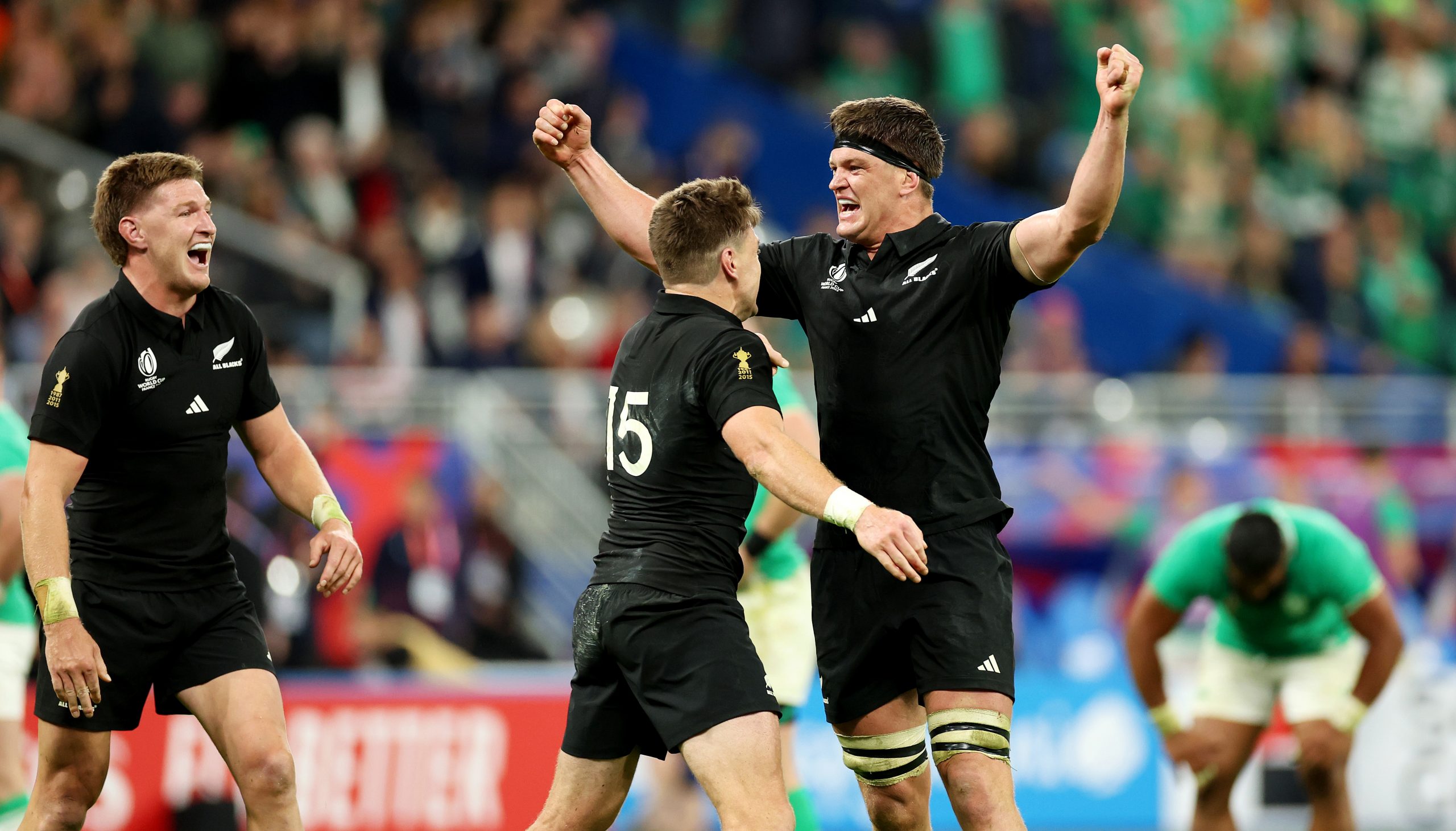 Jordie Barrett, Beauden Barrett and Scott Barrett of New Zealand celebrate.