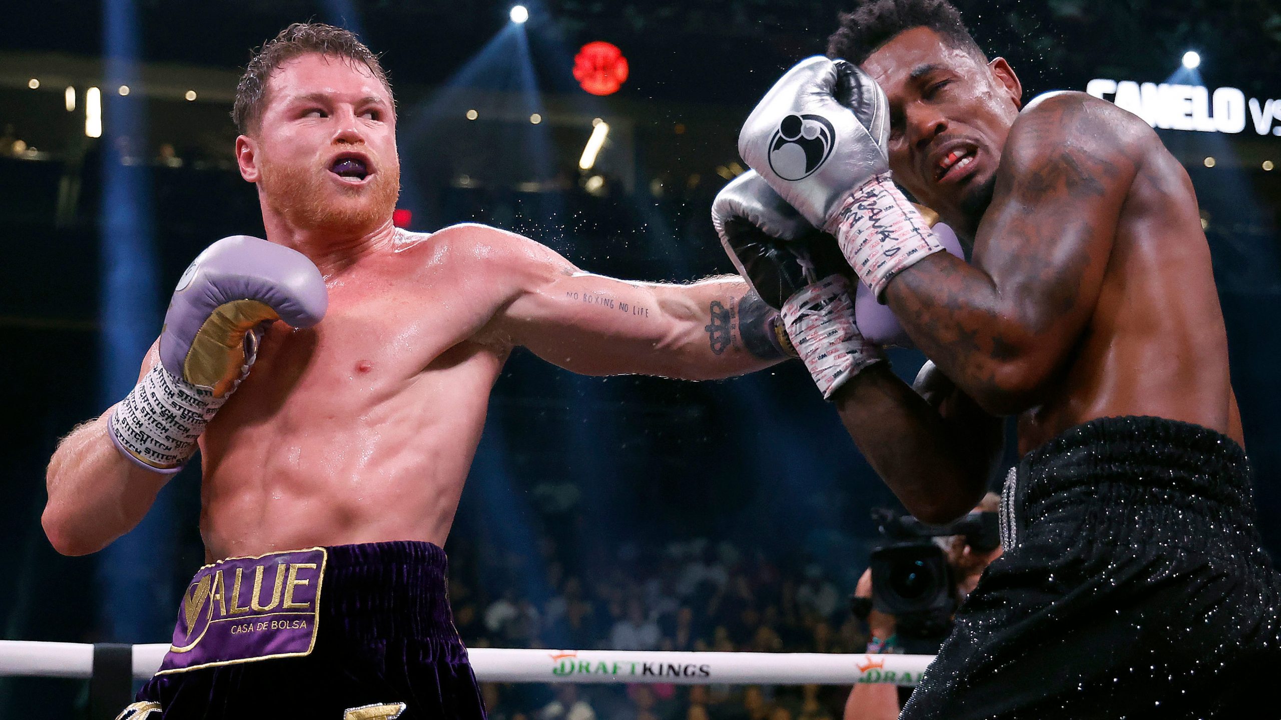 Saul "Canelo" Alvarez of Mexico trades punches with Jermell Charlo during their super middleweight title fight at T-Mobile Arena on September 30, 2023 in Las Vegas, Nevada.