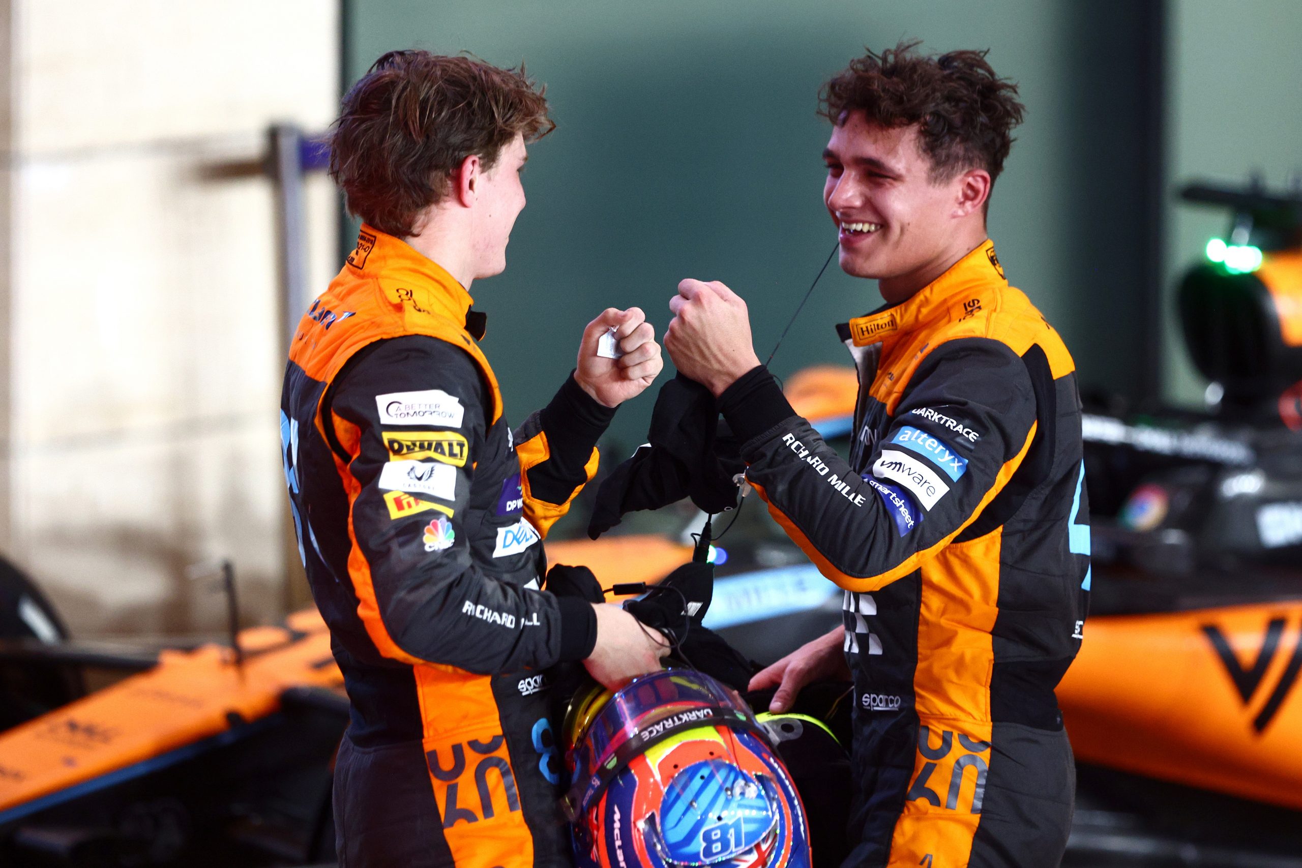 Lando Norris (right) and Oscar Piastri bump fists after finishing second and third respectively in the Qatar Grand Prix.