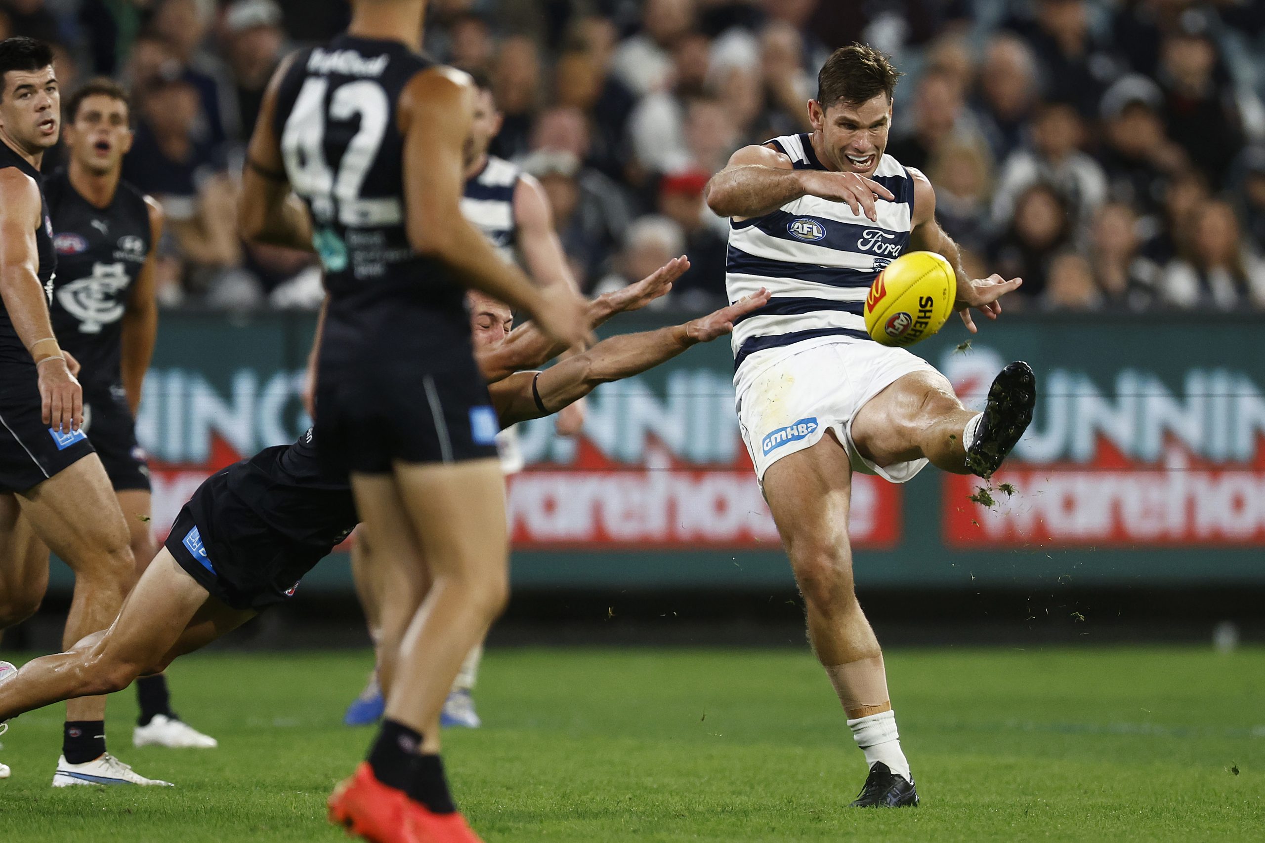 MELBOURNE, AUSTRALIA - MARCH 23: Tom Hawkins of the Cats kicks for goal during the round two AFL match between Carlton Blues and Geelong Cats at Melbourne Cricket Ground, on March 23, 2023, in Melbourne, Australia. (Photo by Daniel Pockett/Getty Images)