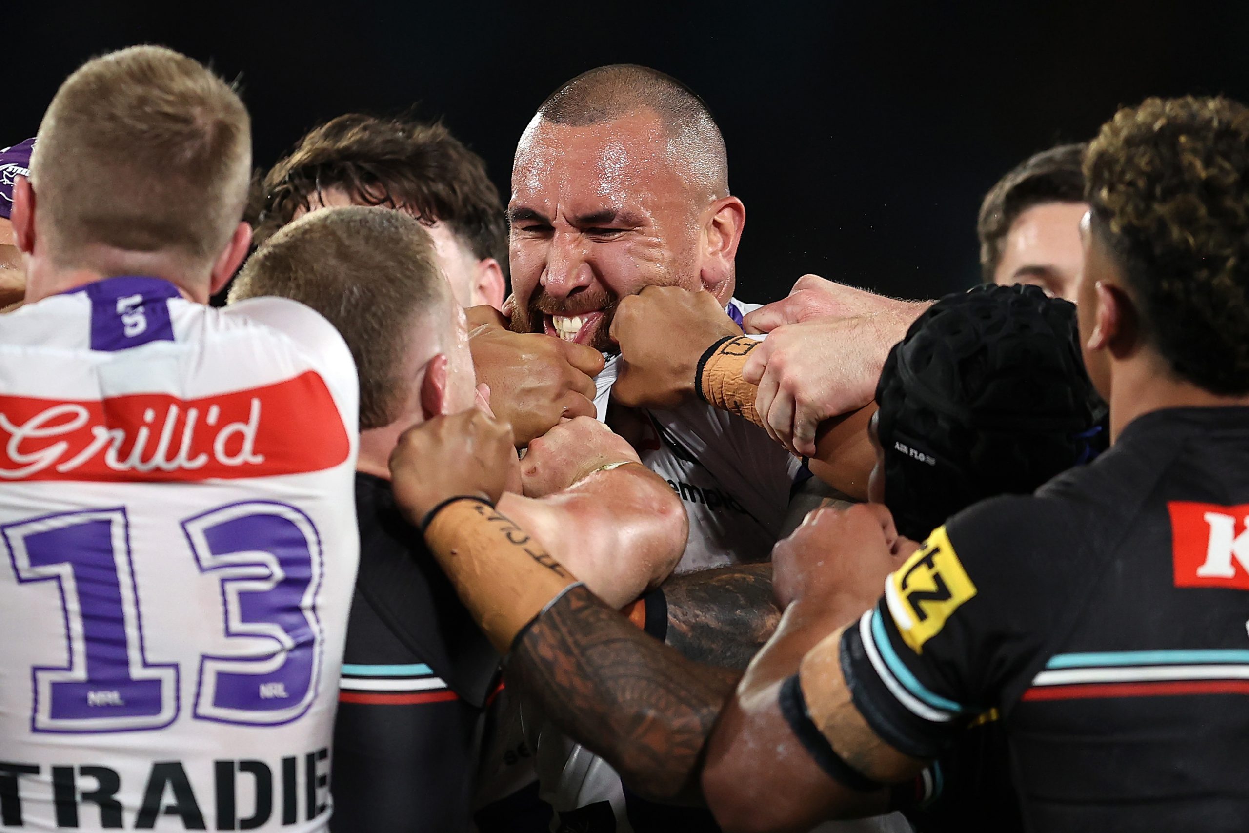 Nelson Asofa-Solomona of the Storm scuffles with Panthers players during the NRL Preliminary Final.