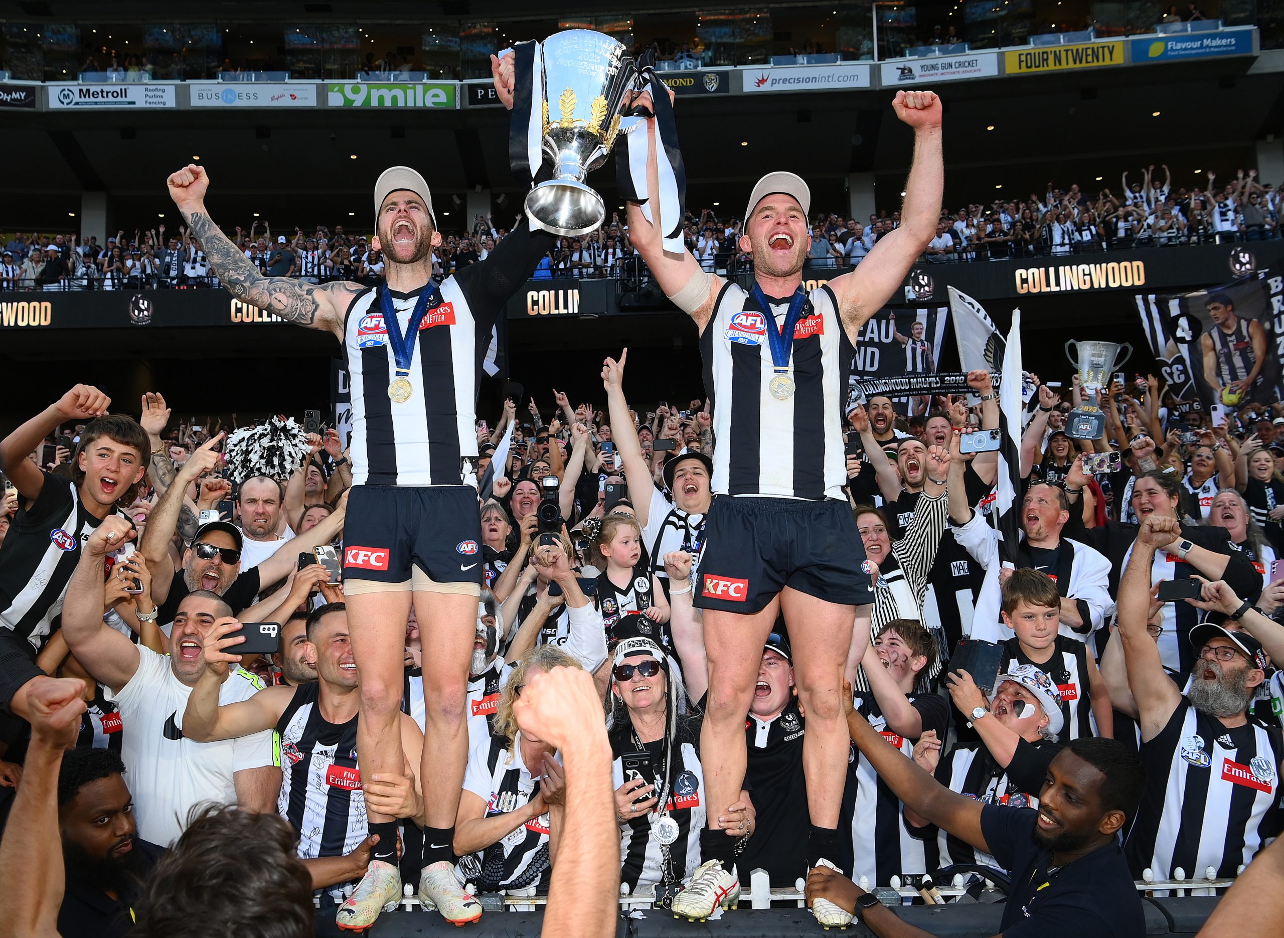 Jeremy Howe (left) and Tom Mitchell celebrate Collingwood's grand final victory over Brisbane.