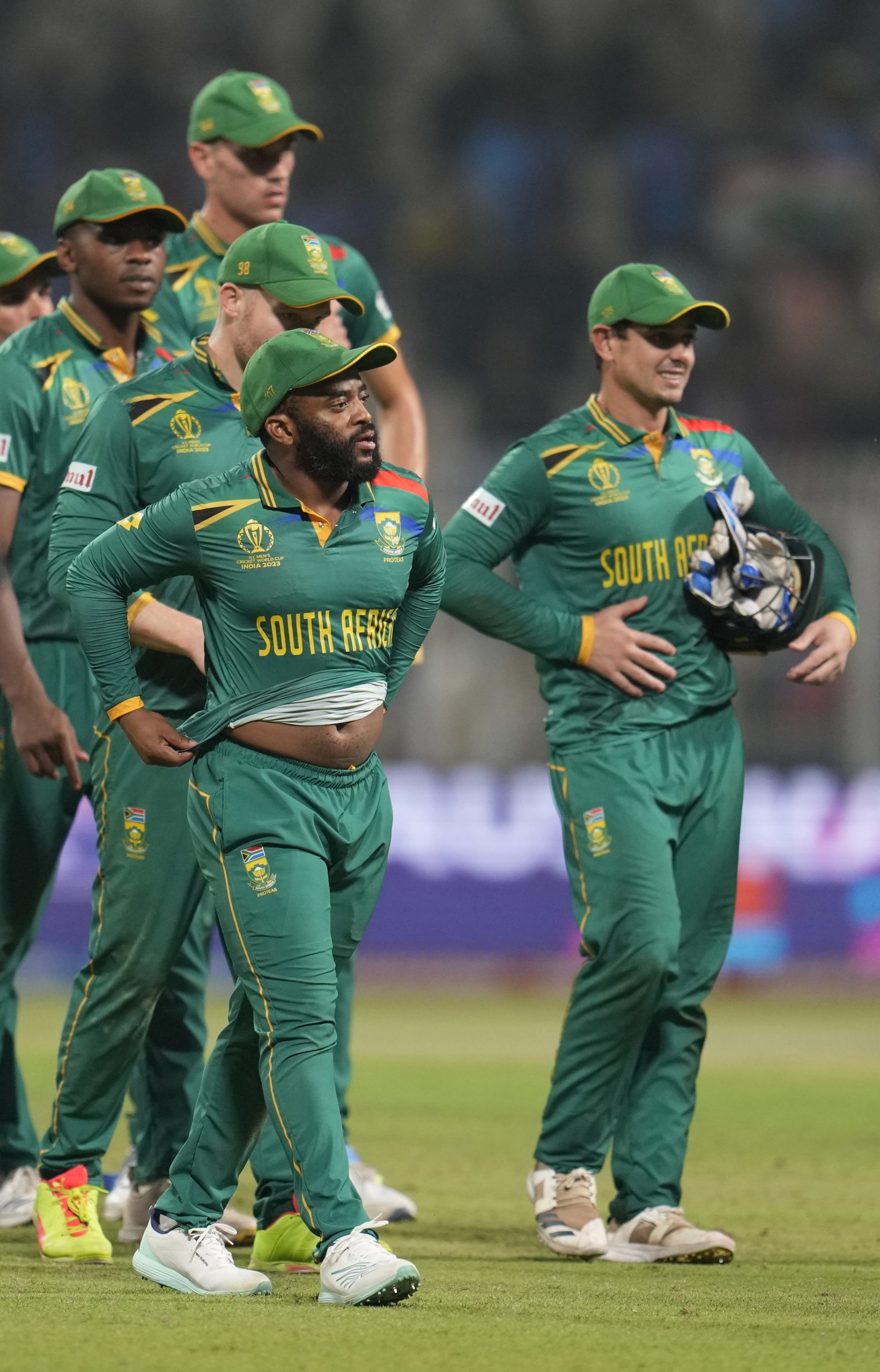 South Africa's captain Temba Bavuma with teammates walk off the field after losing to Australia.