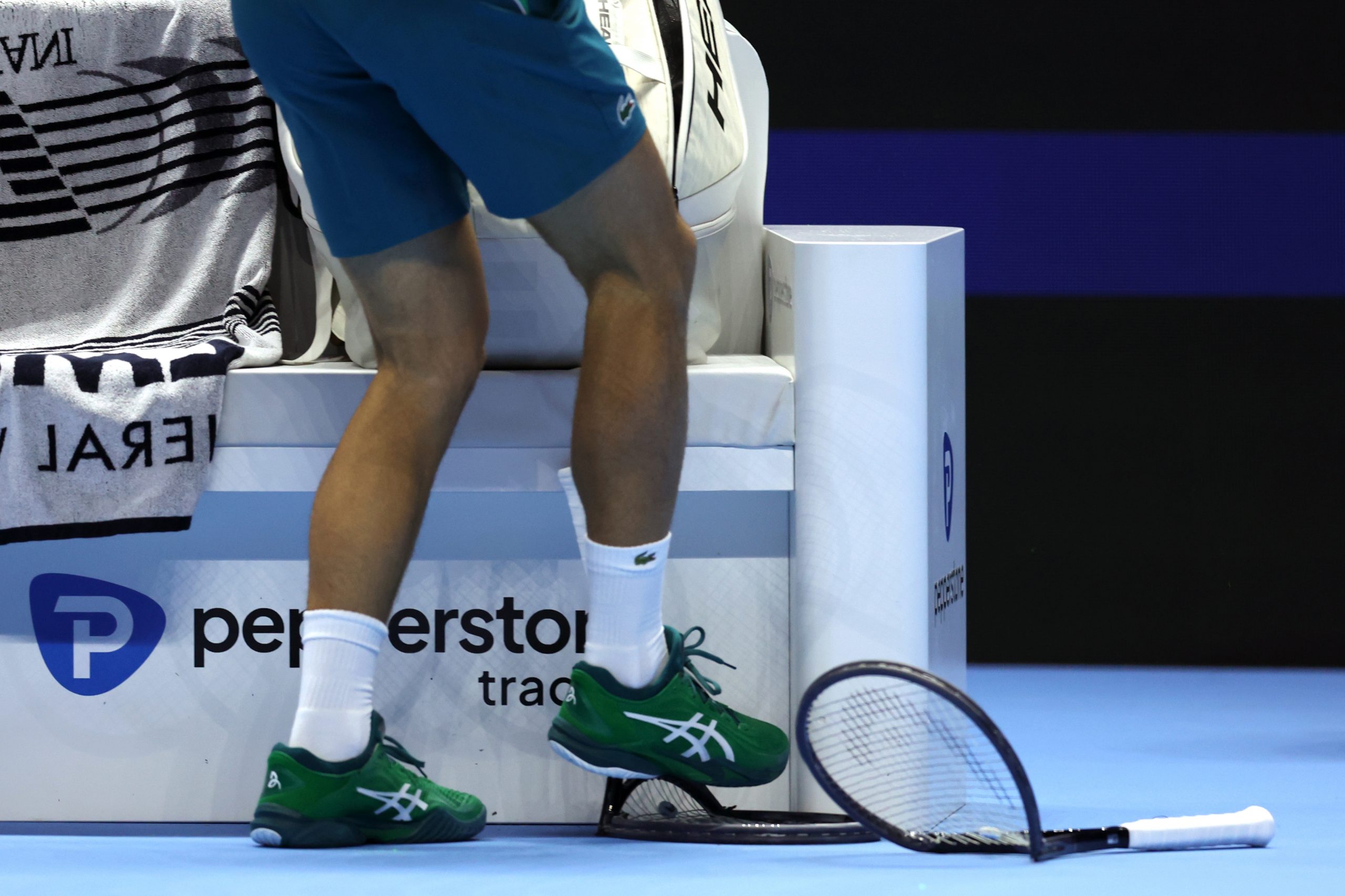 Novak Djokovic stamps on a racket in his opening match at the 2023  ATP Finals.