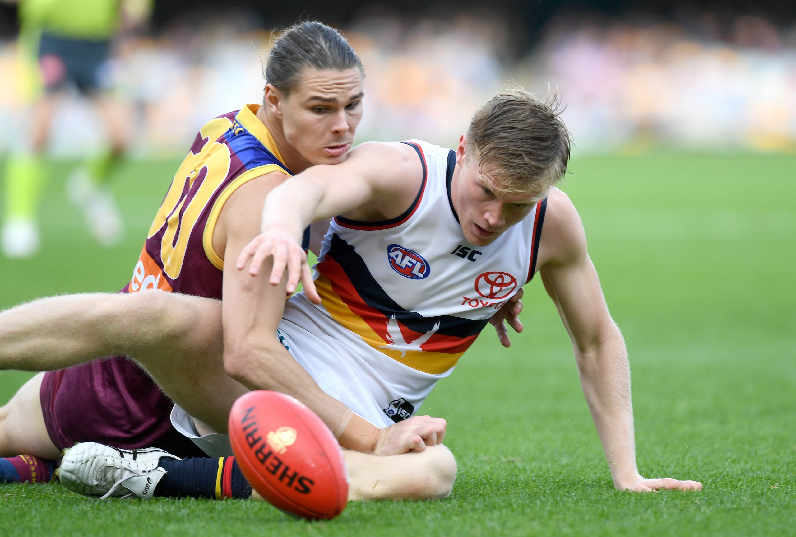 Fischer McAsey of the Crows and Eric Hipwood of the Lions challenge for the ball.