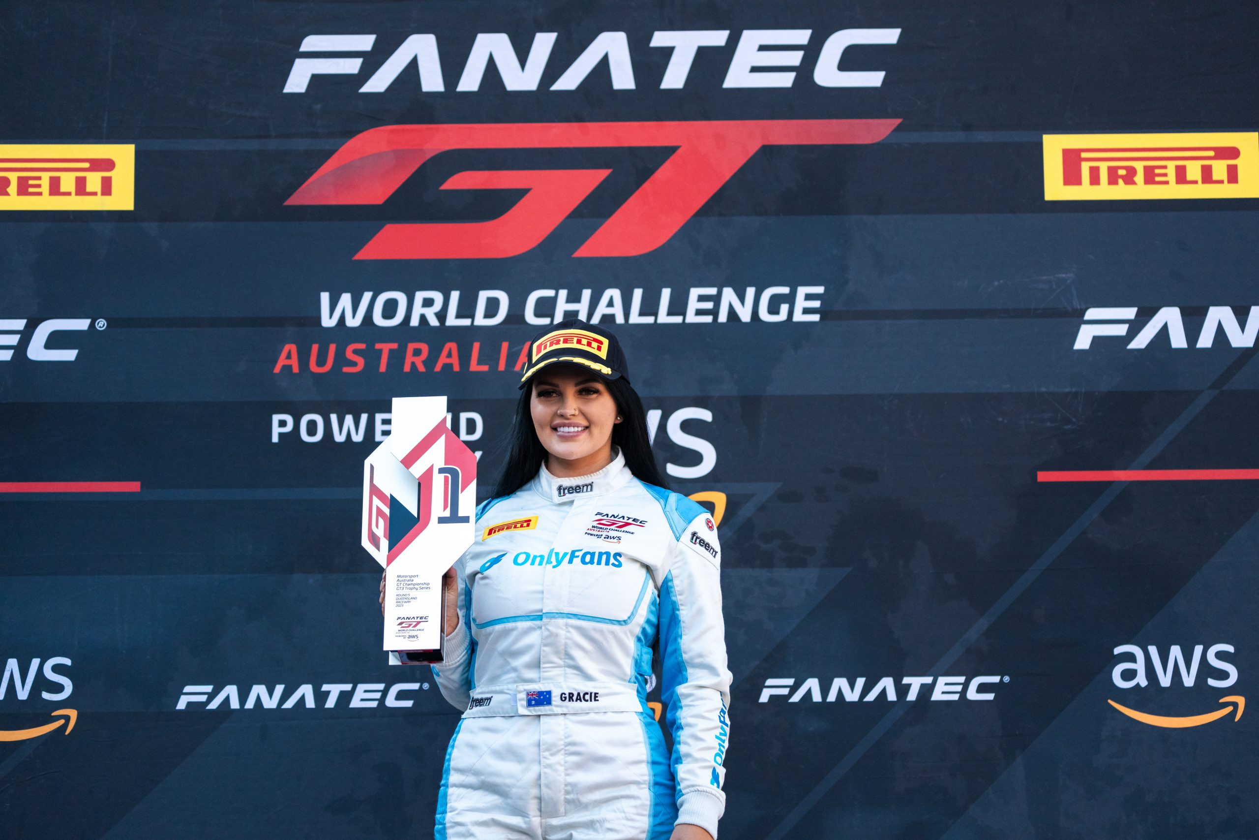 Rene Gracie holds her GT World Challenge Australia Series race winner's trophy.