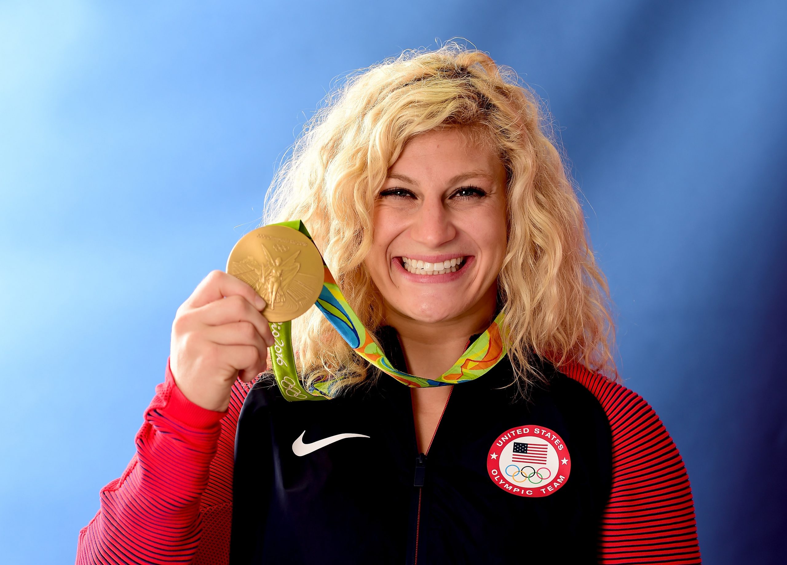 Kayla Harrison celebrates with her gold medal at Copacabana Beach.