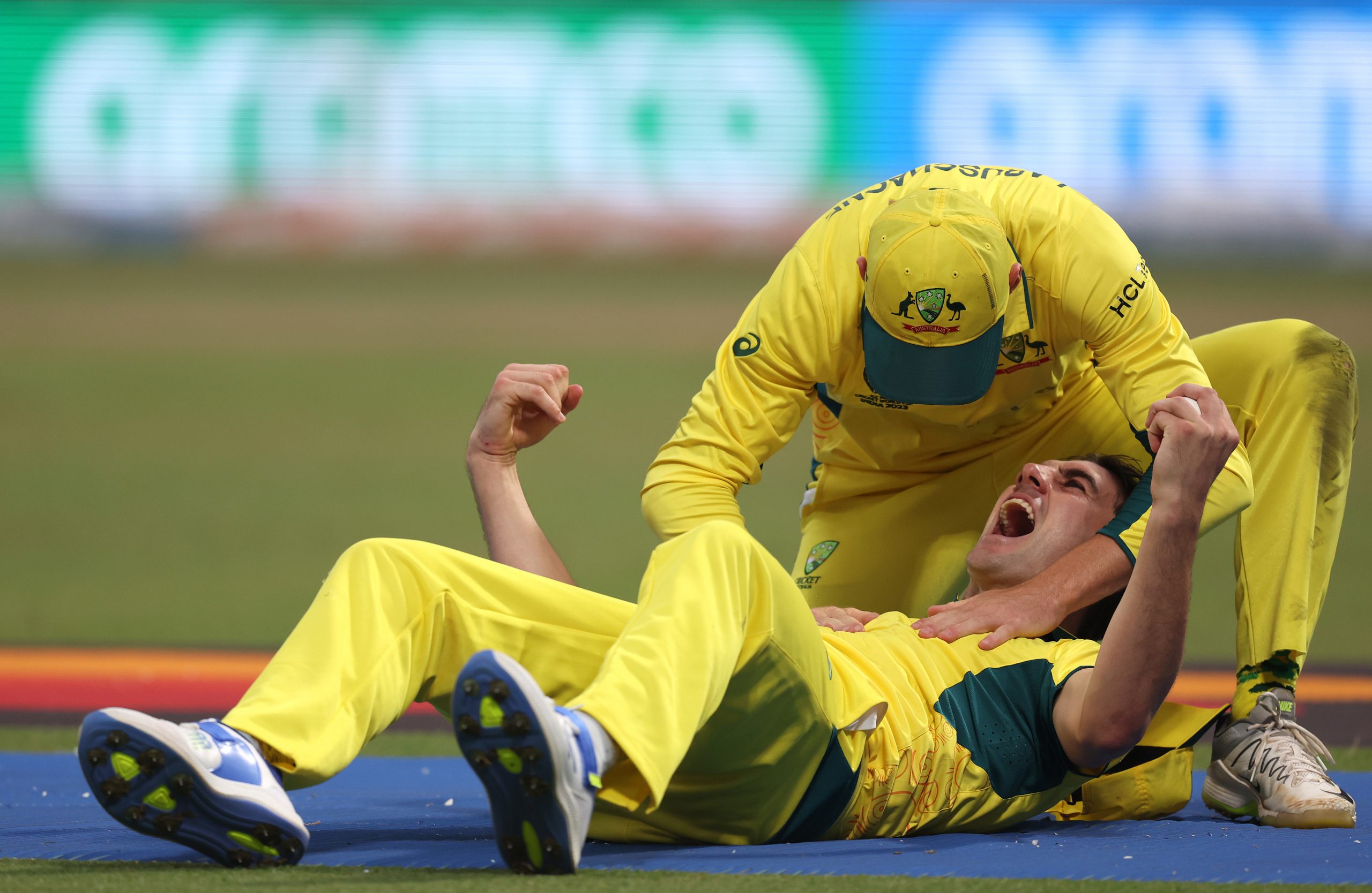 KOLKATA, INDIA - NOVEMBER 16: Pat Cummins of Australia celebrates with teammate Marnus Labuschagne after catching out Quinton de Kock of South Africa (not pictured) during the ICC Men's Cricket World Cup India 2023 Semi Final match between South Africa and Australia at Eden Gardens on November 16, 2023 in Kolkata, India. (Photo by Matthew Lewis-ICC/ICC via Getty Images)