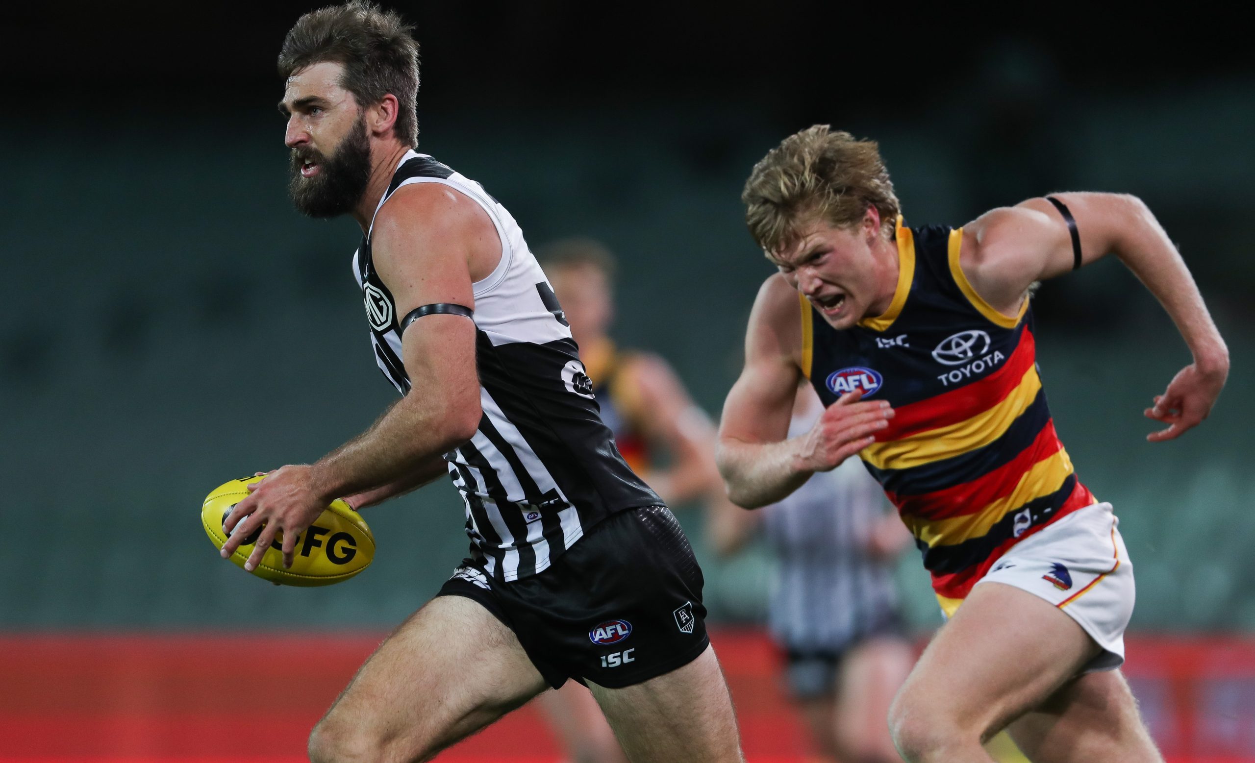 Justin Westhoff of the Power breaks away from Fischer McAsey of the Crows.