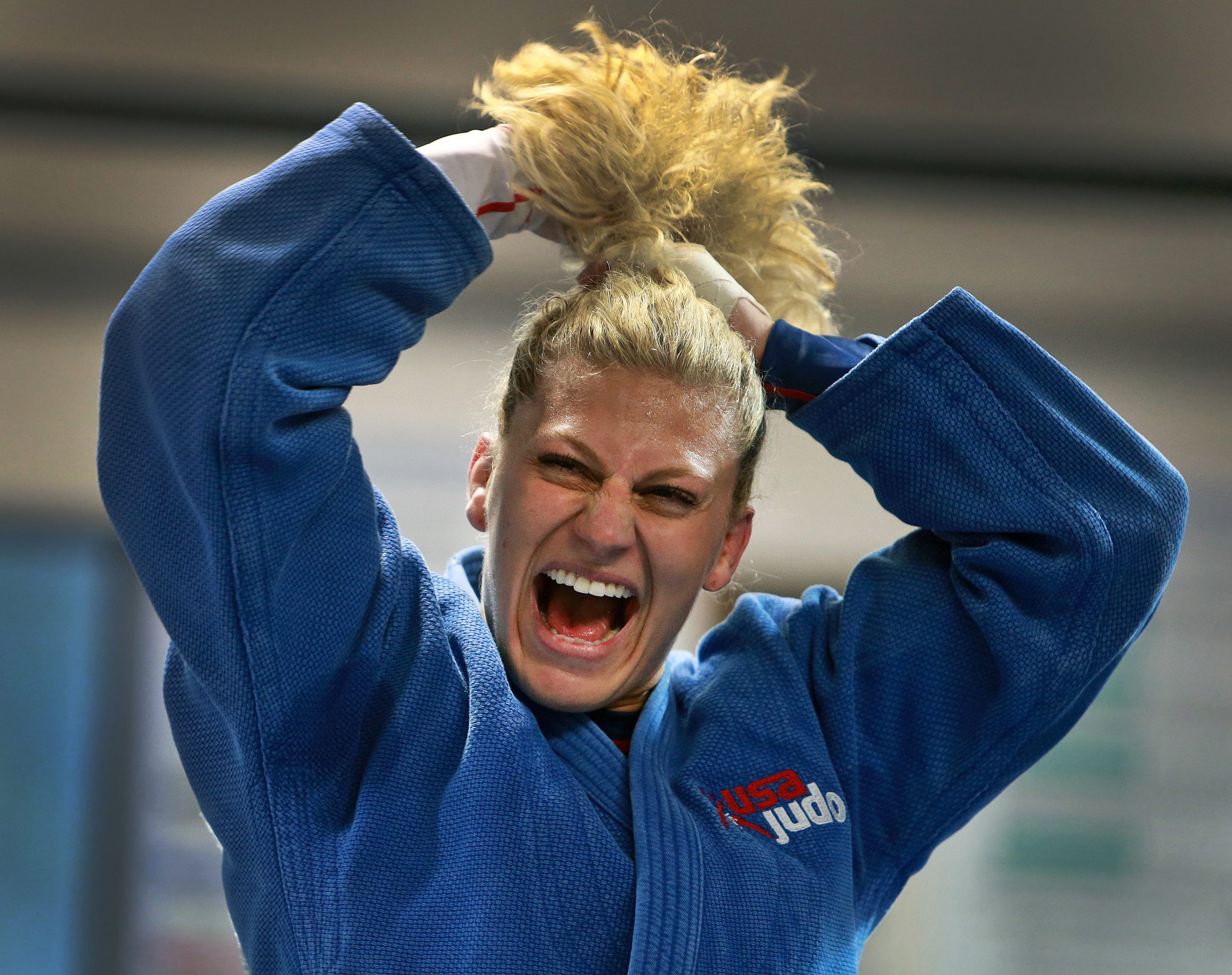 Kayla Harrison laughs while putting her hair up before starting a workout at Pedro's Judo.