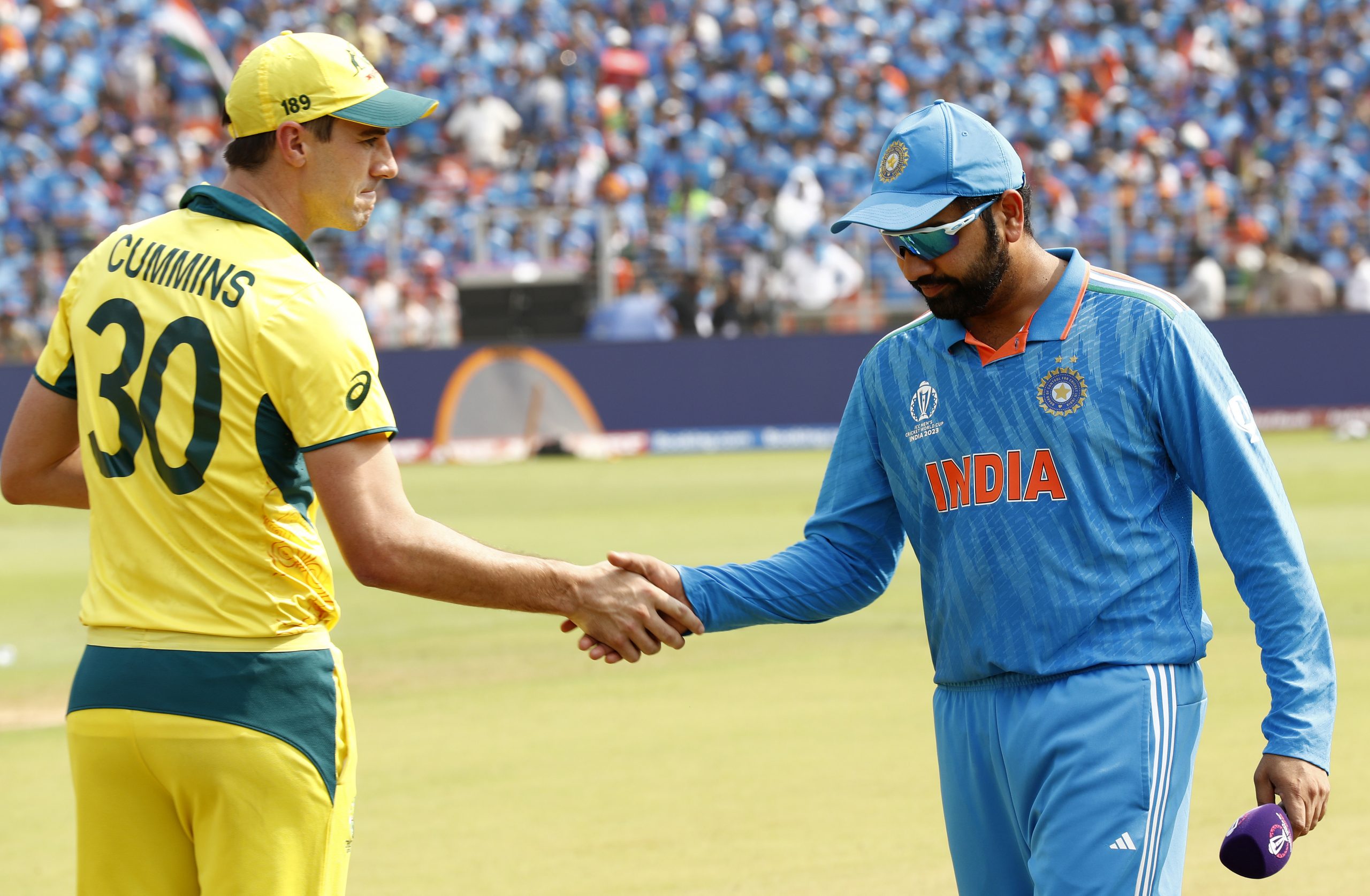 Pat Cummins of Australia and Rohit Sharma of India shake hands ahead of the ICC Men's Cricket World Cup India 2023 Final between India and Australia at Narendra Modi Stadium on November 19, 2023 in Ahmedabad, India. (Photo by Darrian Traynor-ICC/ICC via Getty Images)