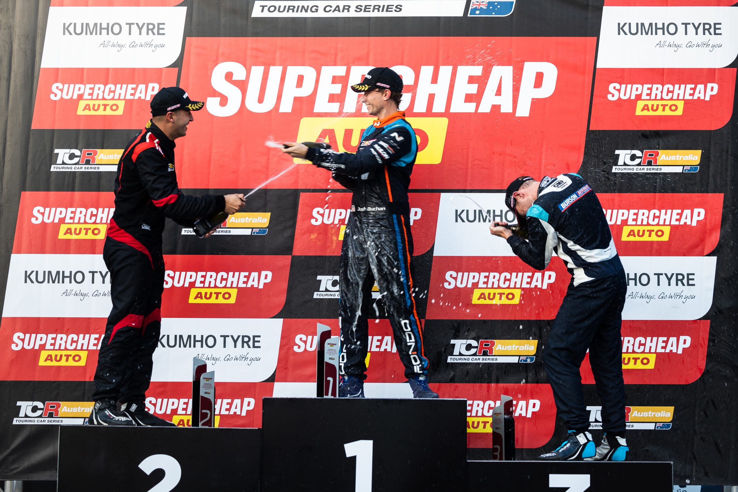 Josh Buchan (middle) stands atop the podium at Phillip Island with Michael Clemente (left) and Bailey Sweeny (right).