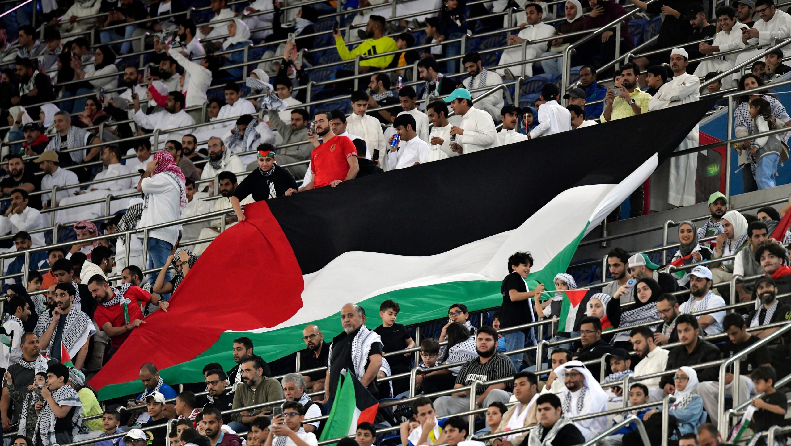 Palestine fans fly the flag in an emotional World Cup qualifying game against the Socceroos.