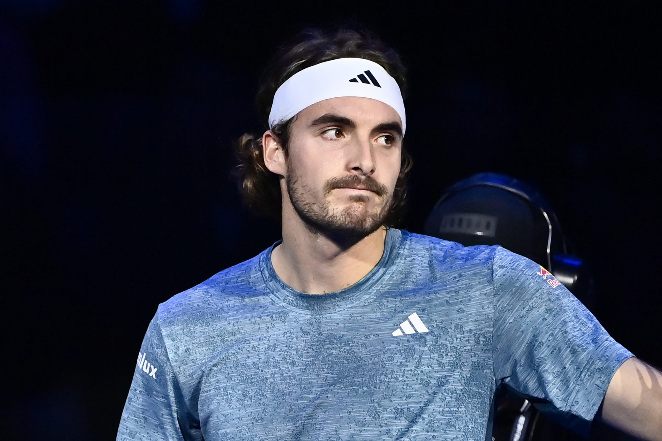 Stefanos Tsitsipas reacts after abandoning his game with Holger Rune because of a back injury.