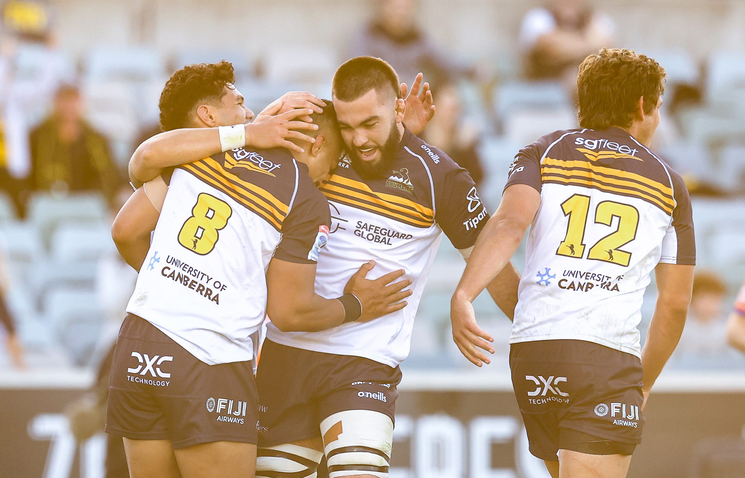 Brumbies players celebrate a try in Super Rugby Pacific.