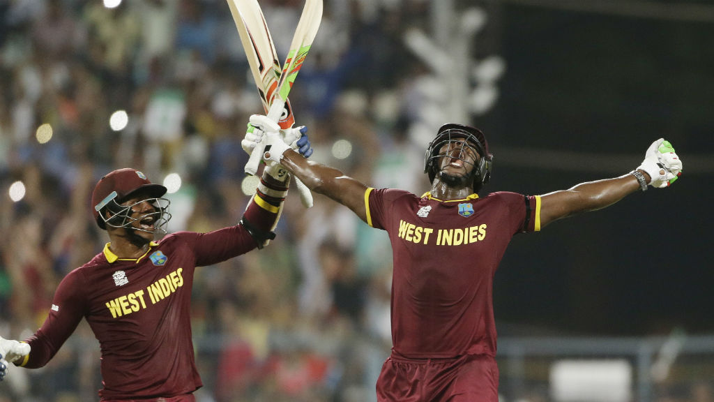 West Indies Carlos Brathwaite, right, celebrates with teammate Marlon Samuels. (AAP)