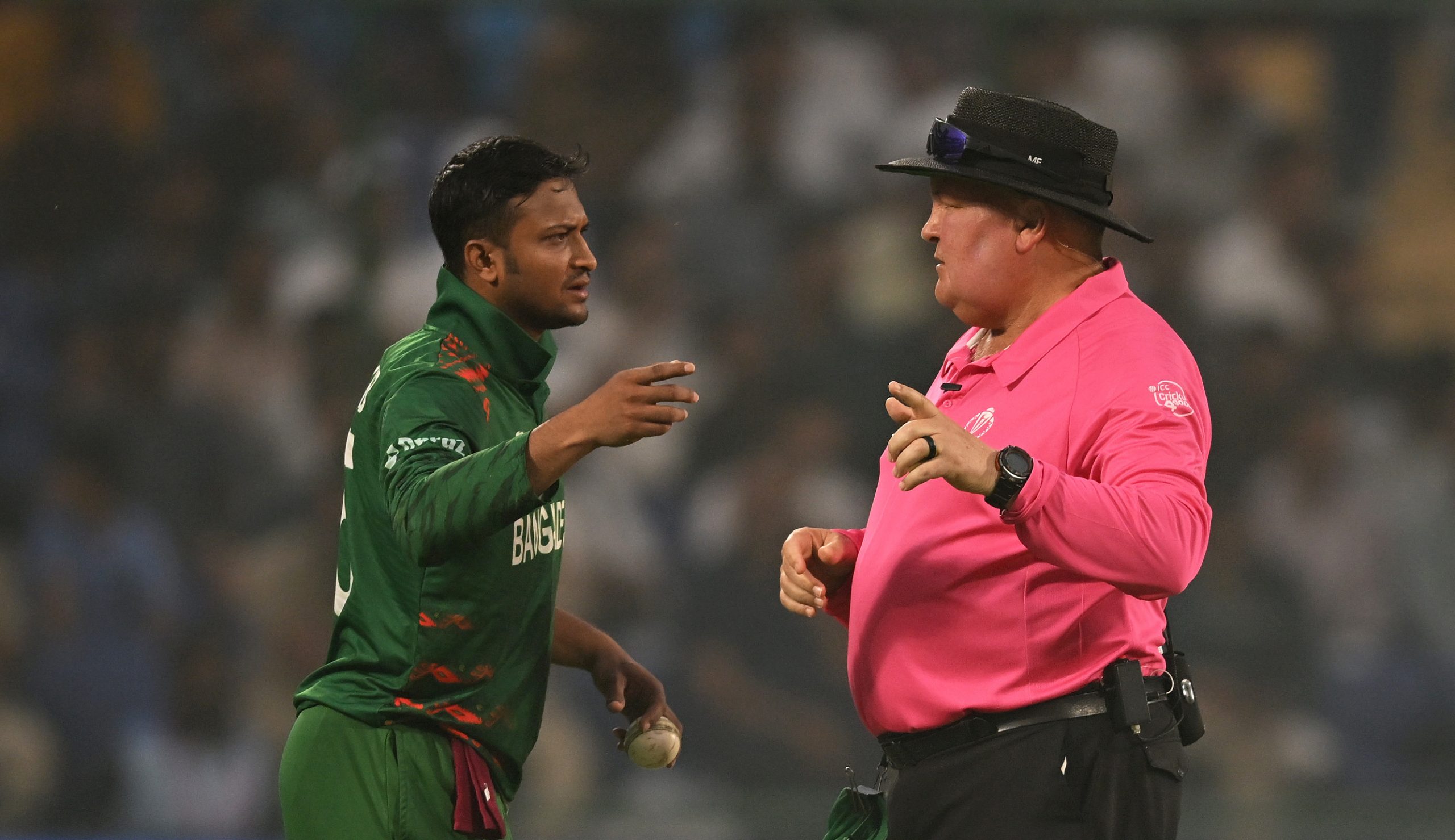 Shakib Al Hasan of Bangladesh and umpire Marais Erasmus interact.