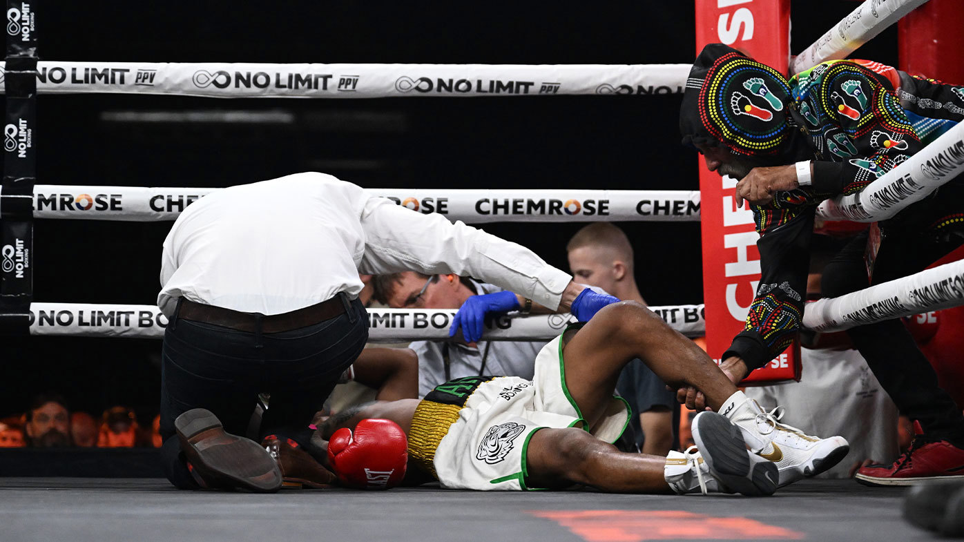 The referee checks in on Shamal Ram Anuj after he was knocked out by Mark Schleibs