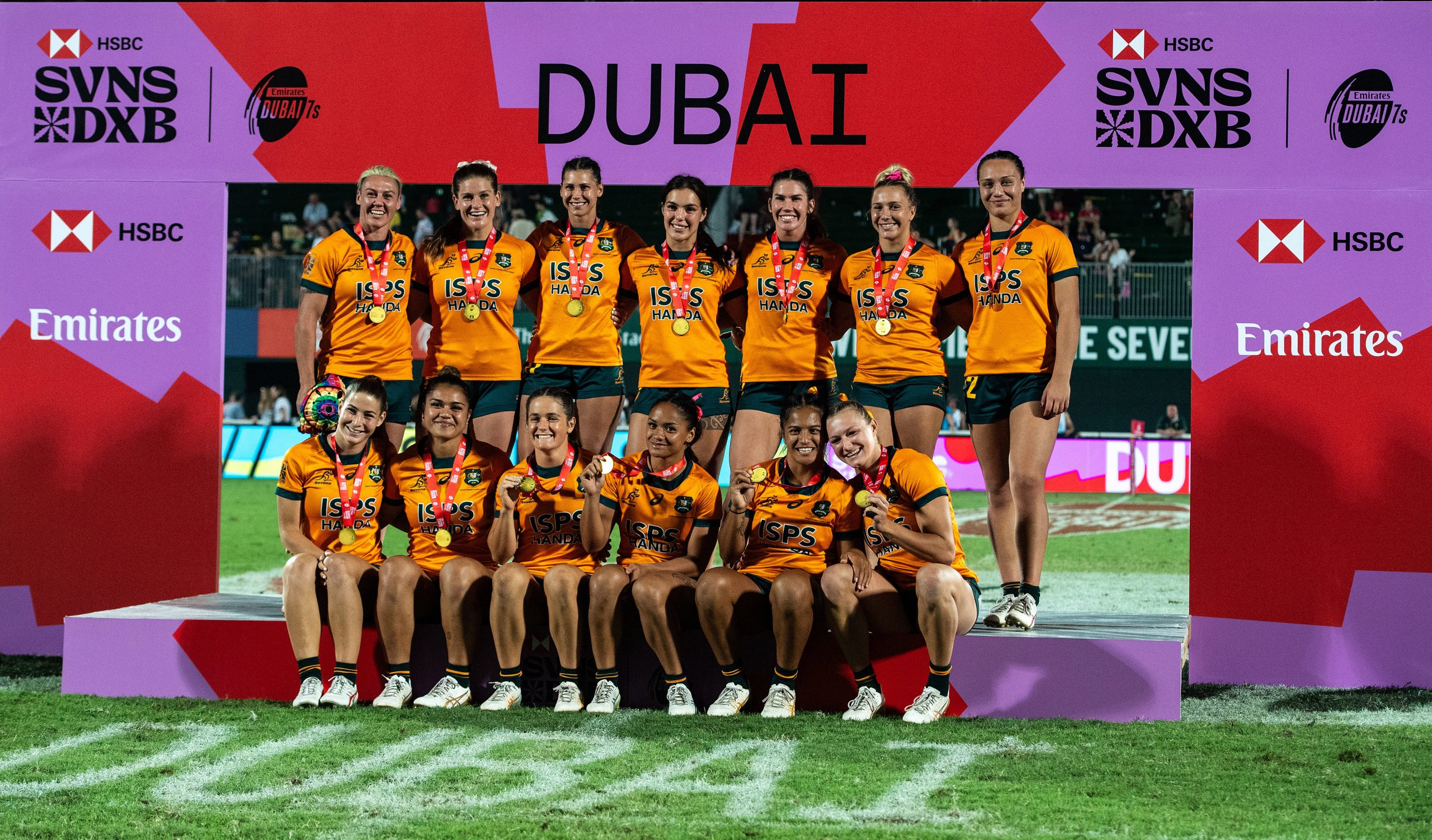 Australian players pose with their medals after winning the final against New Zealand.