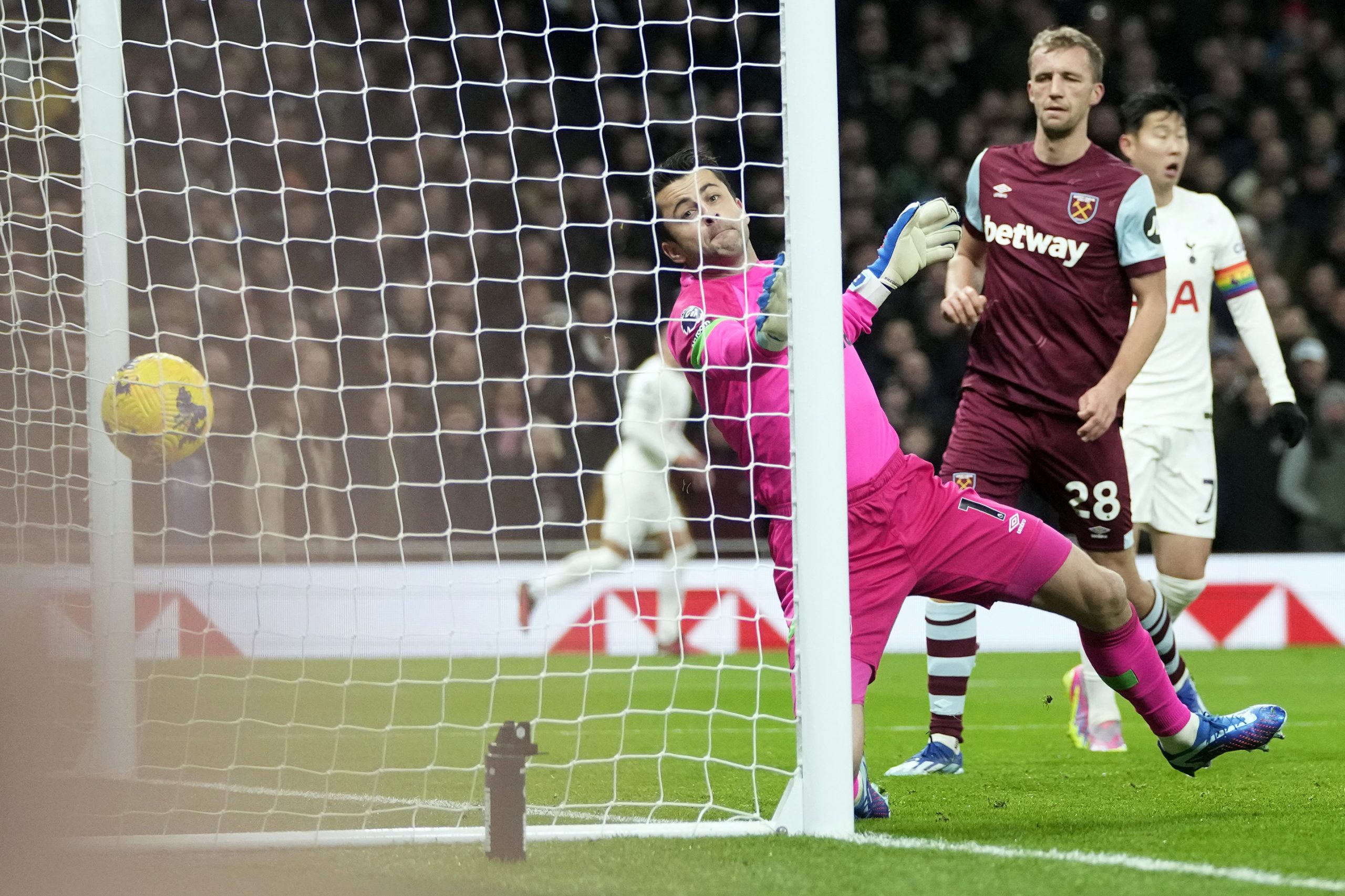 West Ham's goalkeeper Lukasz Fabianski fails to stop the opening goal by Tottenham's Cristian Romero during the English Premier League soccer match between Tottenham Hotspur and West Ham United.