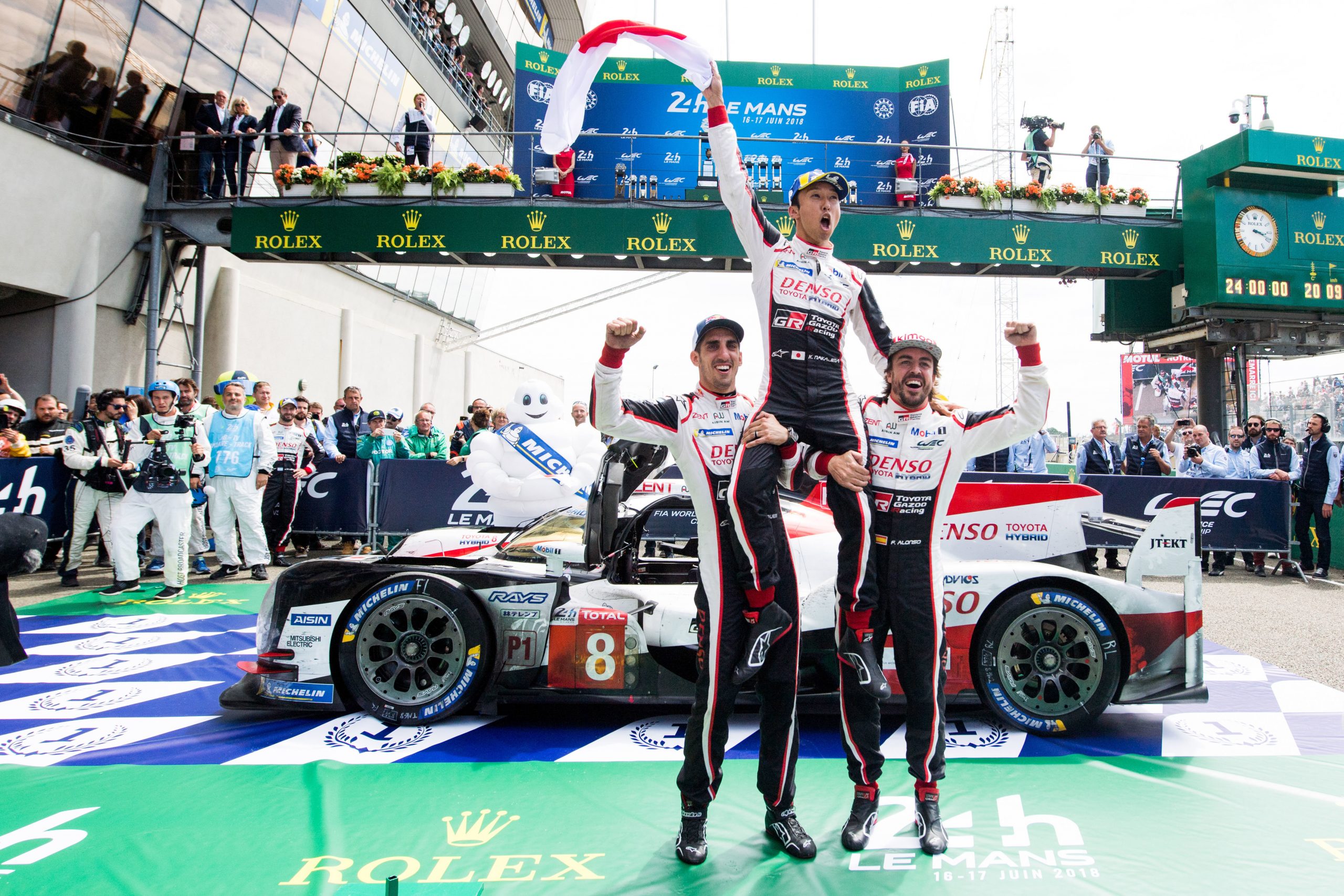 Fernando Alonso (right) and Sebastien Buemi (left) lift Kazuki Nakajima after winning the 24 Hours of Le Mans in 2018.