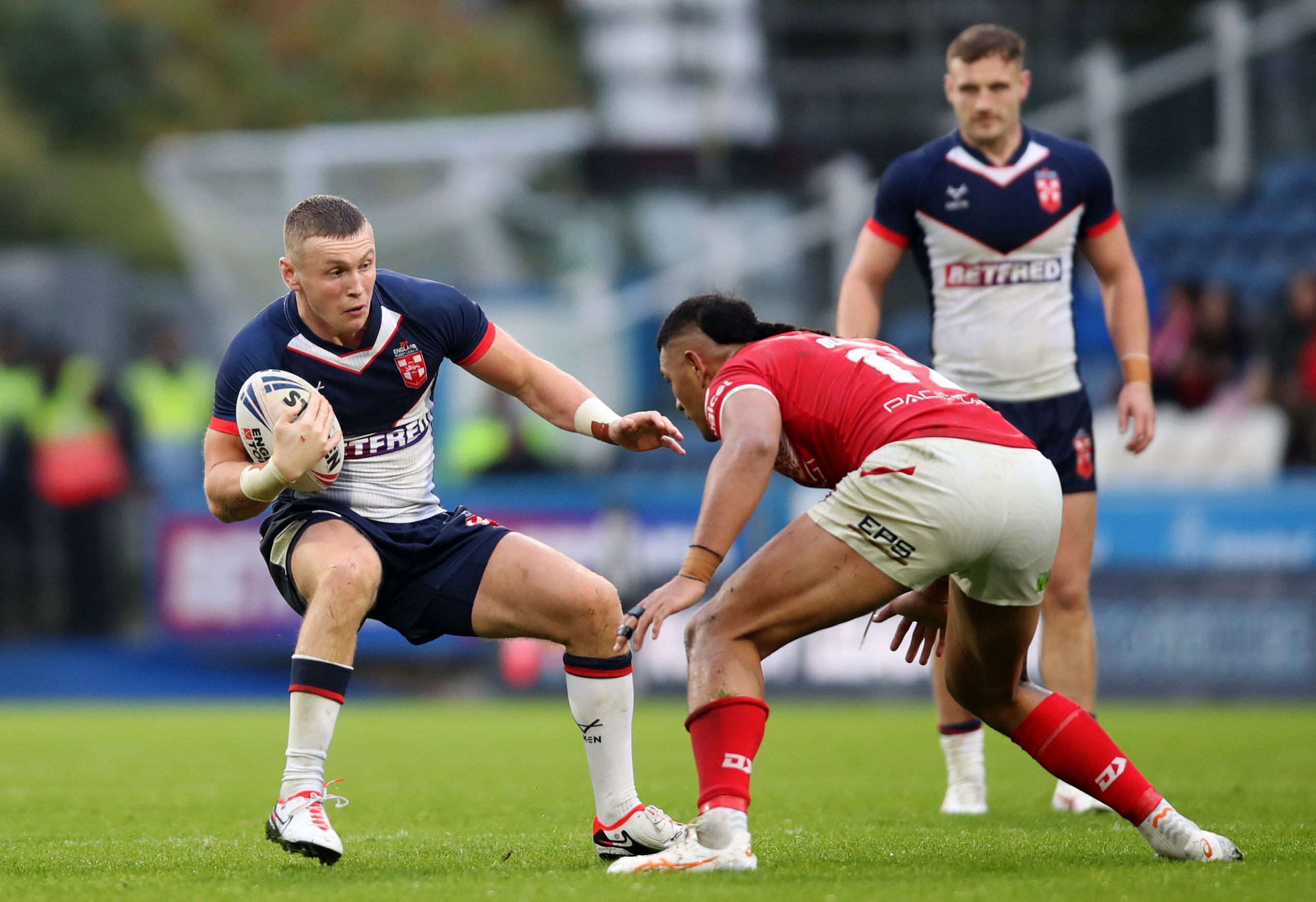 HUDDERSFIELD, ENGLAND - OCTOBER 28: Harry Newman of England is challenged by Haumole Olakau'atu of Tonga during the Autumn Test Series match between England and Tonga at John Smith's Stadium on October 28, 2023 in Huddersfield, England. (Photo by Jess Hornby/Getty Images)